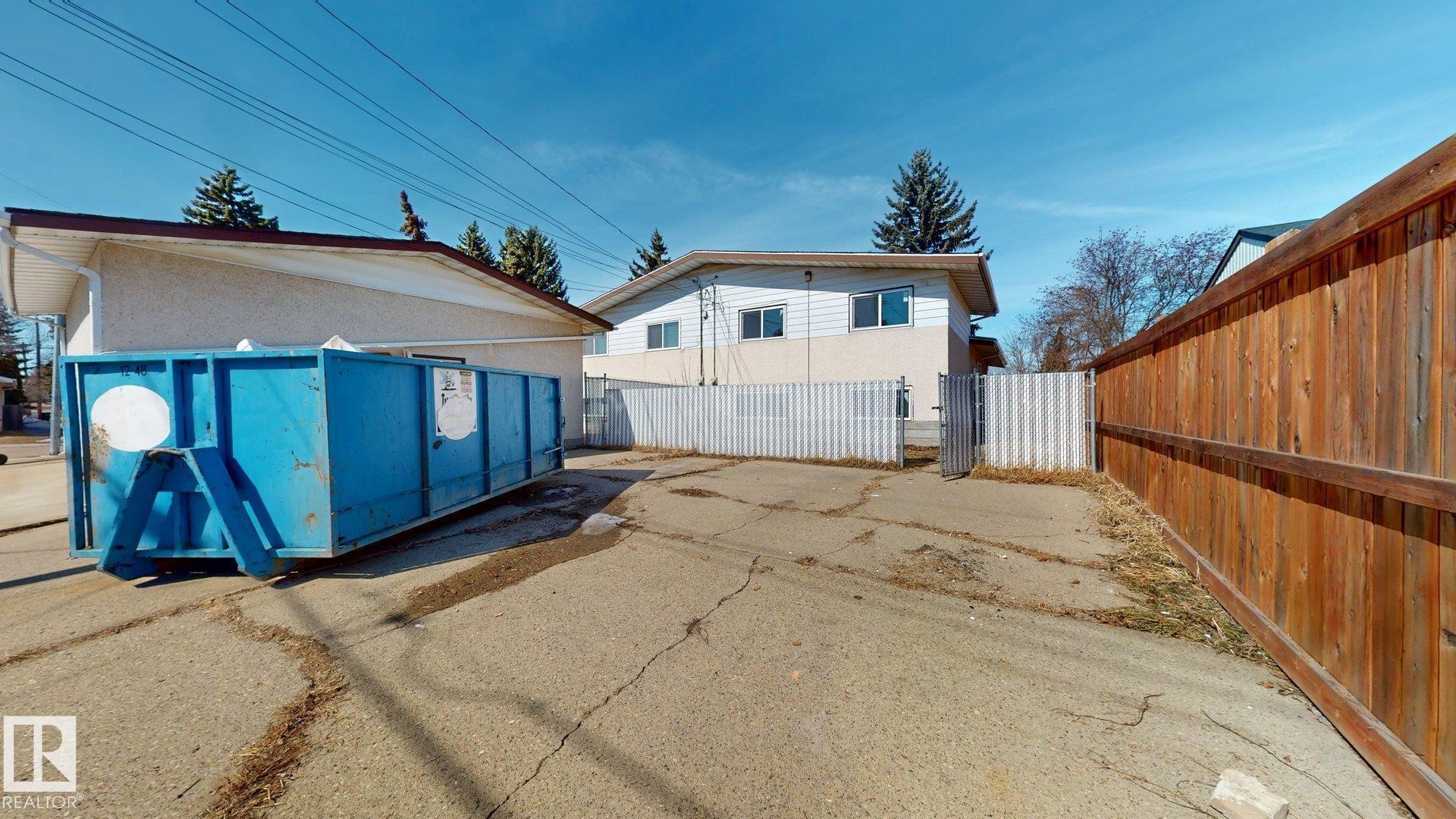 The property includes a wooden fence and a metal fence - 8515 86 Avenue, Edmonton, AB - Outdoor With Exterior