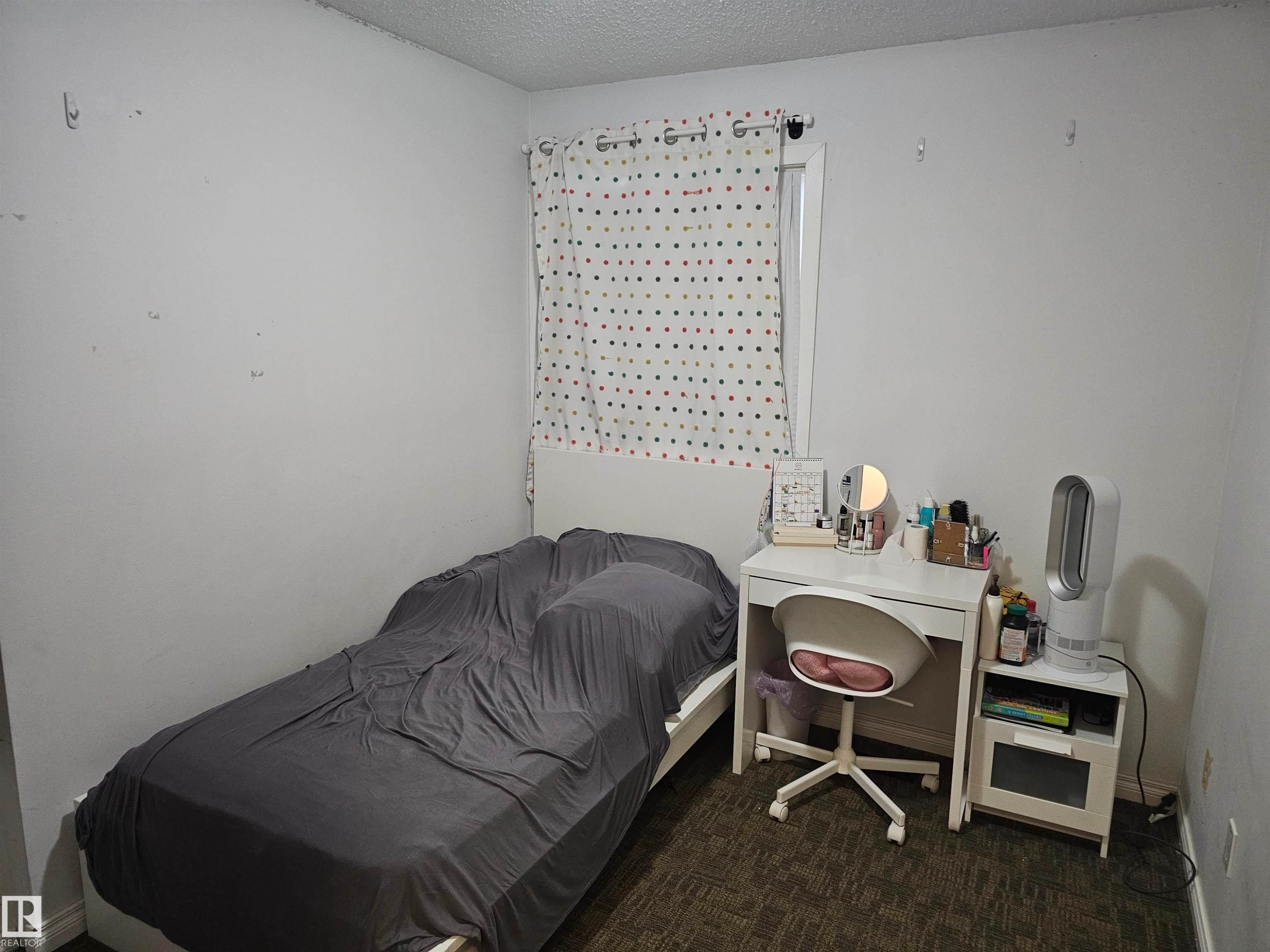 This room features a window with a patterned curtain, a bed frame, and carpeted flooring - 844 Erin Place, Edmonton, AB - Indoor Photo Showing Bedroom