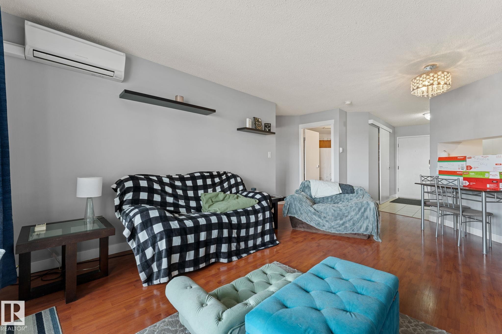The living area features hardwood flooring, light gray walls, and a white ceiling - 208 6710 158 Avenue, Edmonton, AB
