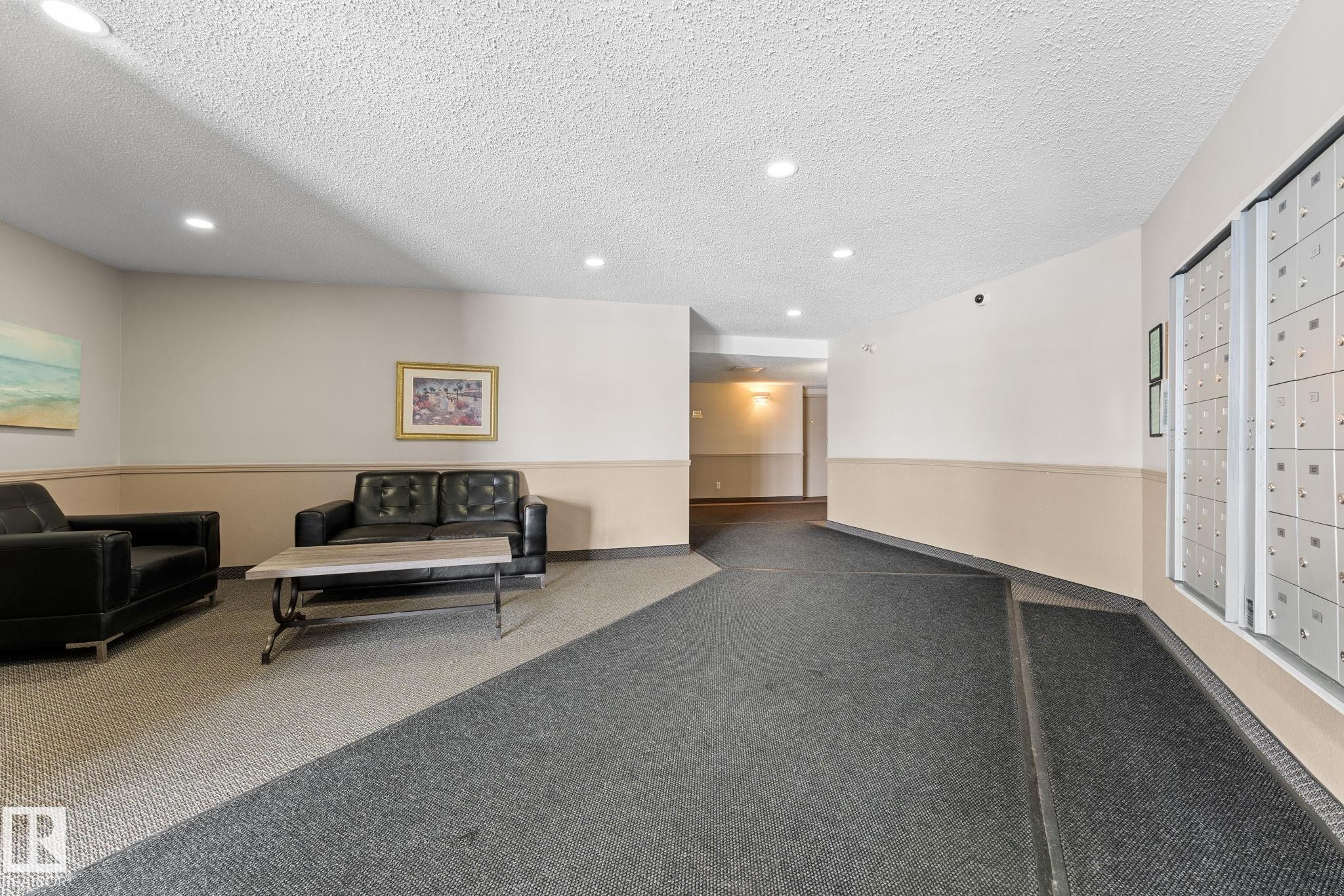 The common area features recessed lighting, a two-tone wall finish, and a combination of carpeted and tiled flooring - 208 6710 158 Avenue, Edmonton, AB
