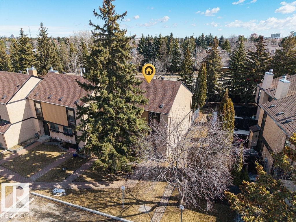 The property features a brown shingle roof and a light-colored exterior - 12032 25 Avenue, Edmonton, AB - Outdoor
