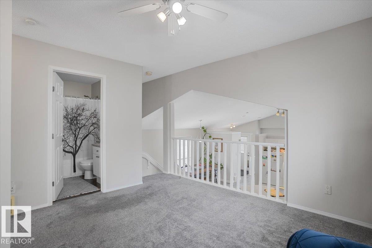 Property interior with grey carpet flooring, white walls, and a white ceiling fan - 3119 32 Avenue, Edmonton, AB - Indoor Photo Showing Other Room