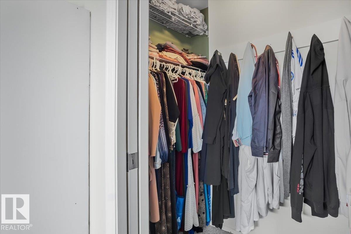 Walk-in closet with hanging clothes storage and a wire shelf - 3119 32 Avenue, Edmonton, AB - Indoor With Storage