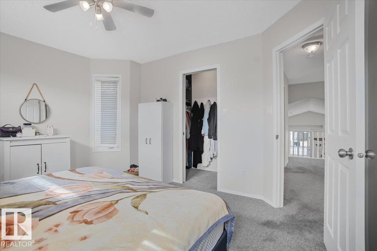 Bedroom with light gray walls, a window with blinds, and a ceiling fan with light fixture - 3119 32 Avenue, Edmonton, AB - Indoor Photo Showing Bedroom