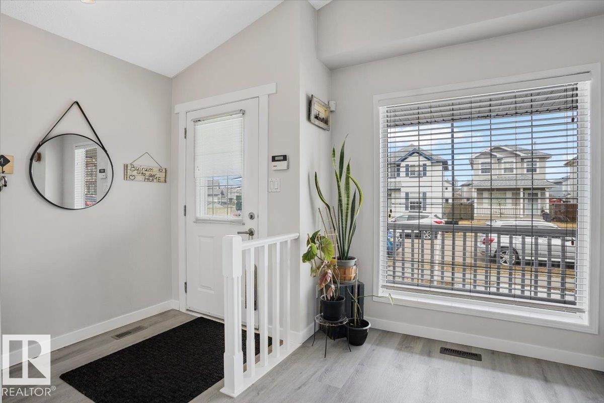 Entryway featuring light-colored walls and a window with horizontal blinds - 3119 32 Avenue, Edmonton, AB - Indoor Photo Showing Other Room