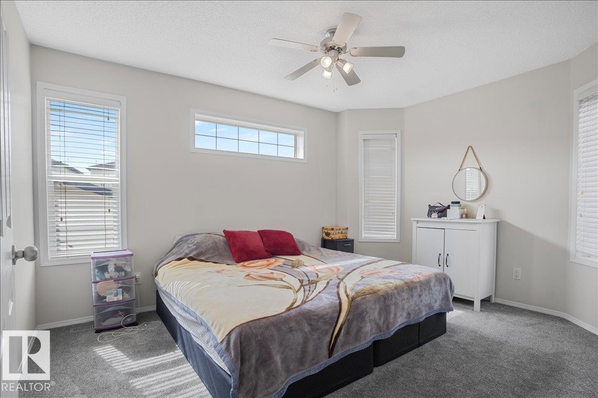 This room features light grey walls and grey carpeting, creating a neutral palette - 3119 32 Avenue, Edmonton, AB - Indoor Photo Showing Bedroom