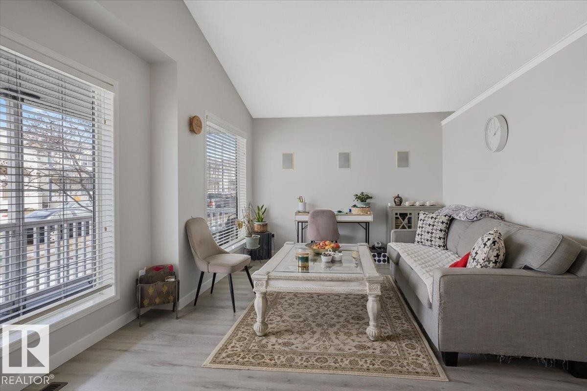 The living area features light-colored walls and flooring, with large windows that provide natural light - 3119 32 Avenue, Edmonton, AB - Indoor Photo Showing Living Room