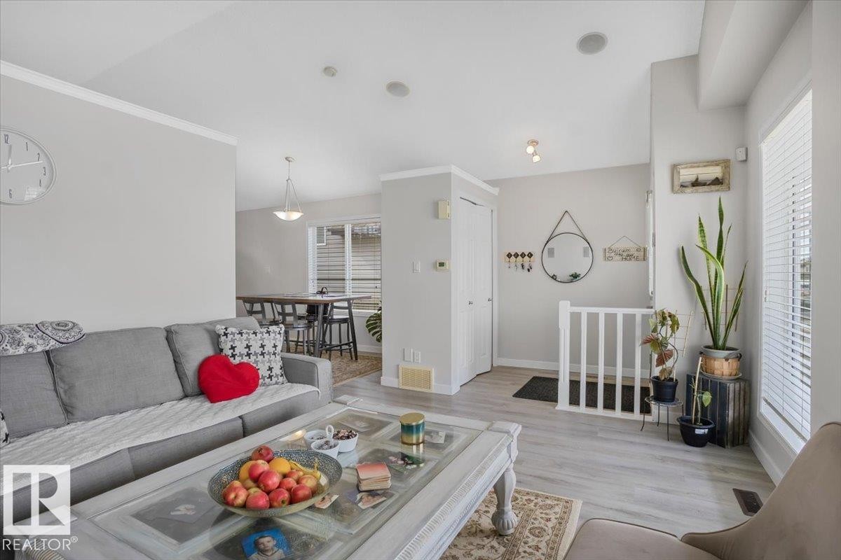 Living area featuring light gray walls, white trim, and light-colored flooring - 3119 32 Avenue, Edmonton, AB - Indoor Photo Showing Living Room