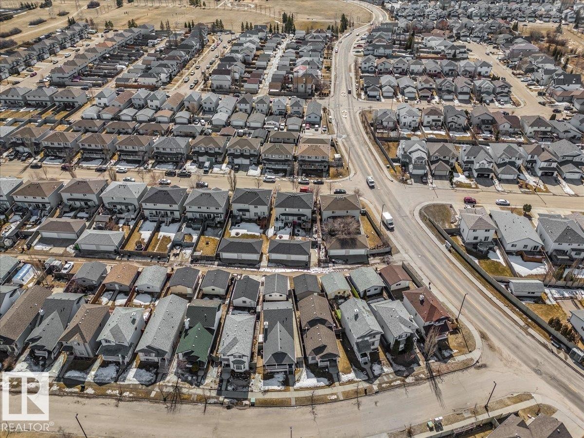 An aerial view showcases the property within a well-established residential area, featuring an extensive network of roads and numerous houses with varied rooflines - 3119 32 Avenue, Edmonton, AB - Outdoor With View