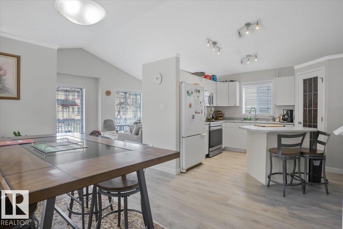 The property features an open-concept layout with light-toned flooring throughout - 3119 32 Avenue, Edmonton, AB - Indoor Photo Showing Dining Room