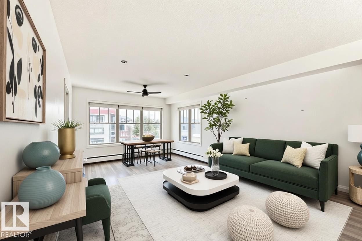 Open-concept living area featuring light wood-finish flooring, white walls, and abundant natural light from multiple windows - 301 103 Ambleside Drive, Edmonton, AB - Indoor Photo Showing Living Room