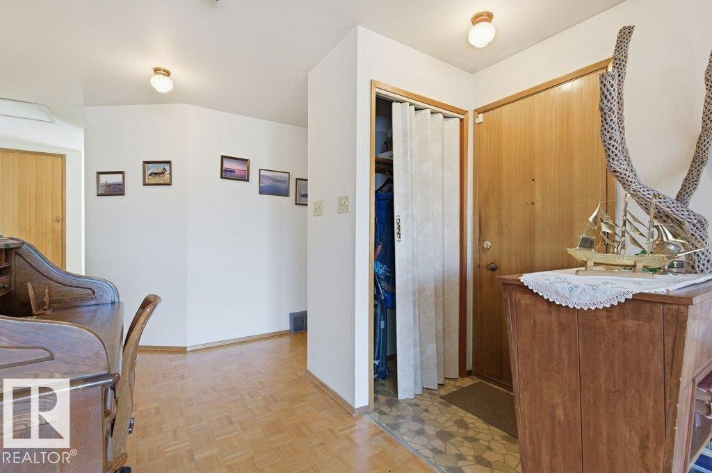The property features light-colored wooden flooring and white walls, creating a bright and airy atmosphere - 10459 66 Avenue, Edmonton, AB - Indoor