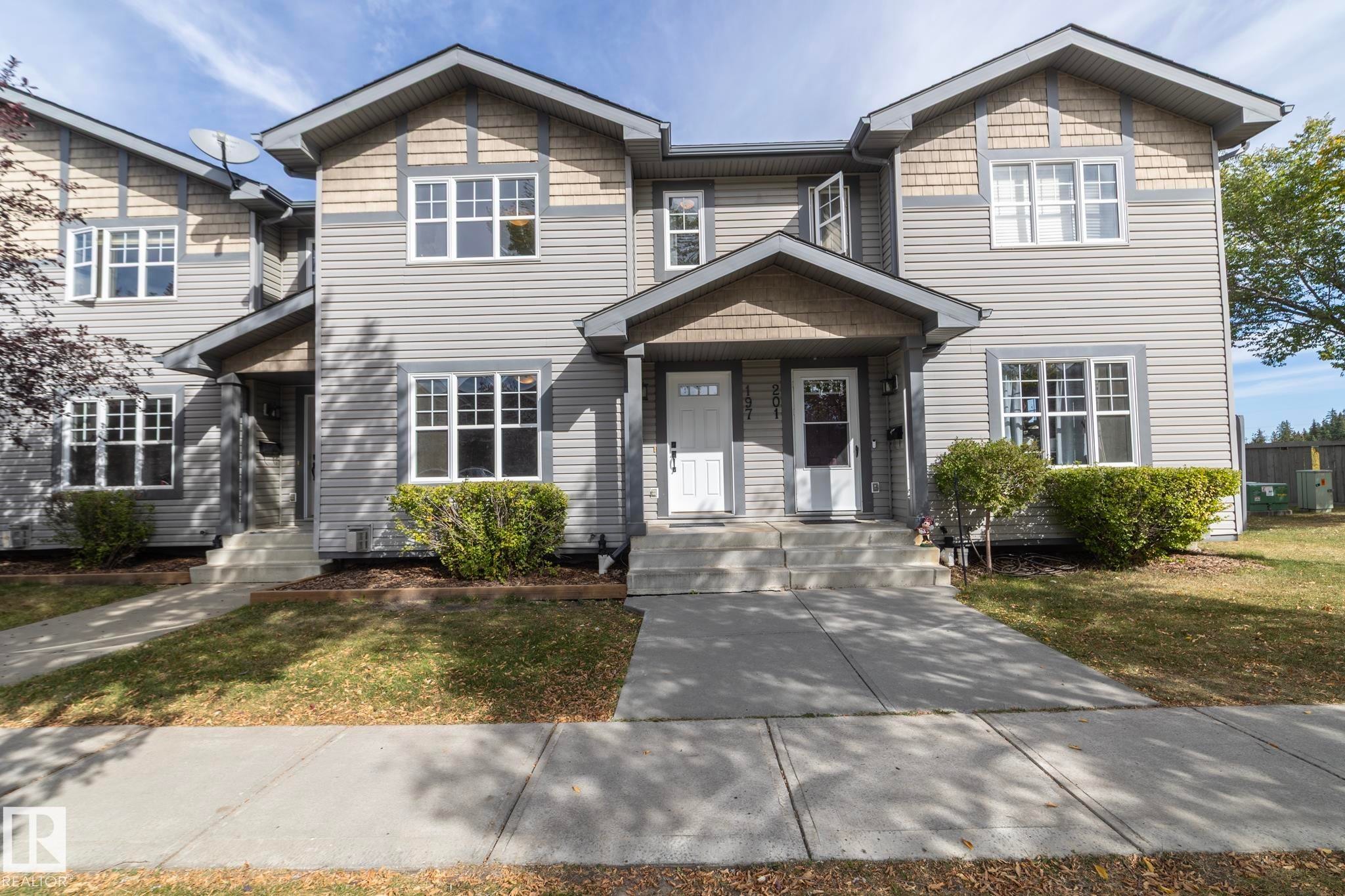 The property features siding and decorative shingles on the facade, with a concrete pathway leading to the entrance - 197 Birchwood Close, Devon, AB - Outdoor With Facade