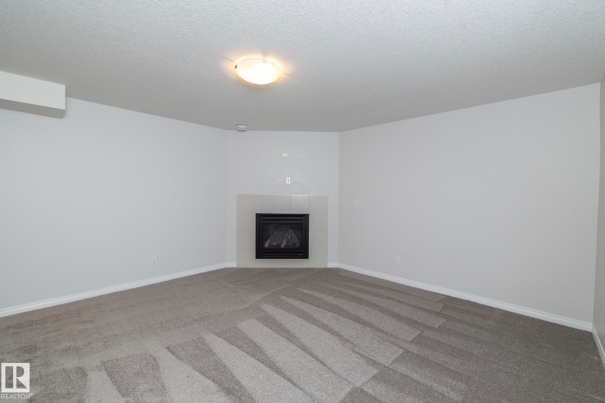 197 Birchwood Close, Devon, AB - Indoor Photo Showing Living Room With Fireplace