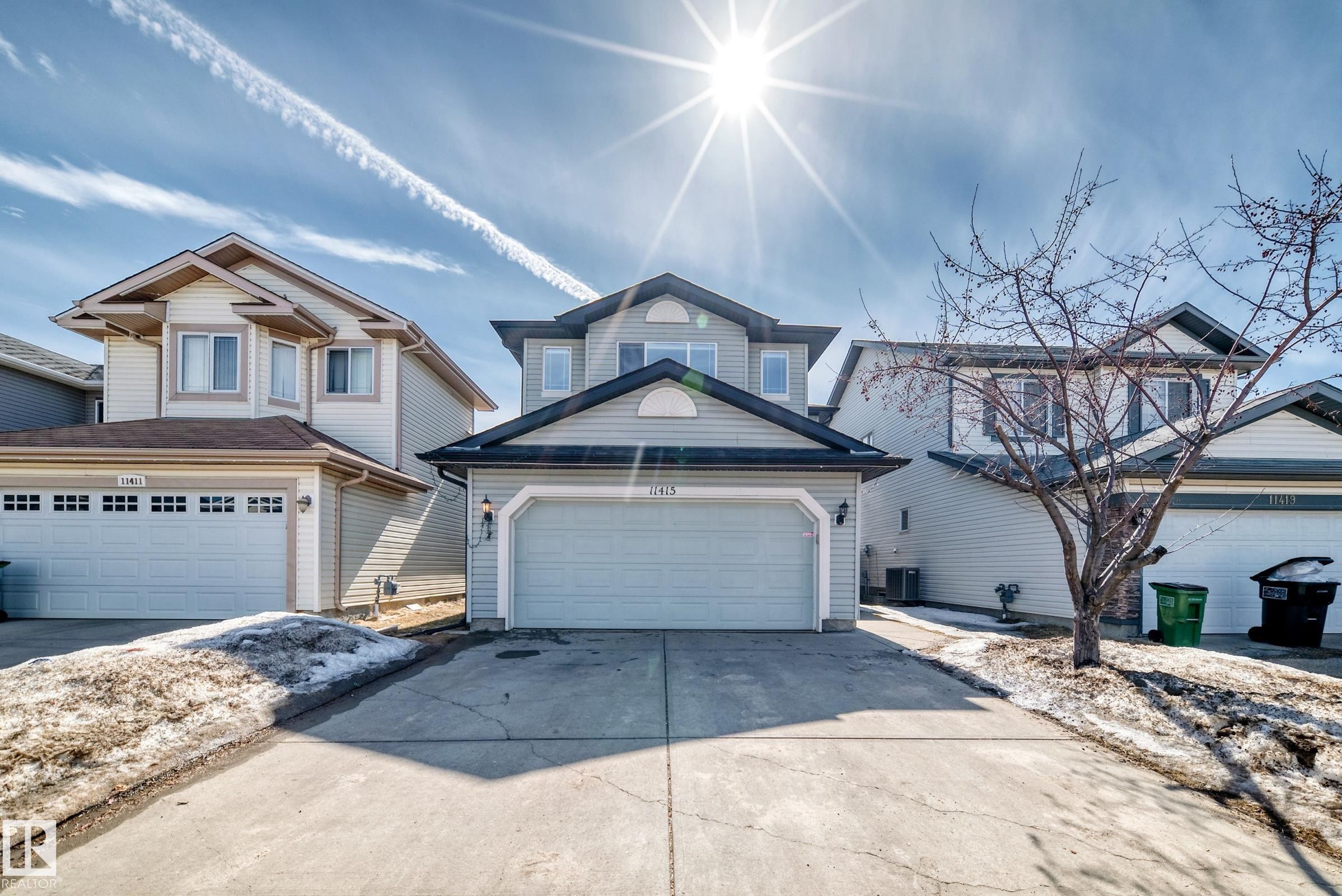 The property features a multi-story exterior with light-colored siding and a dark-shingled roof - 11415 167A Avenue Nw, Edmonton, AB - Outdoor With Facade