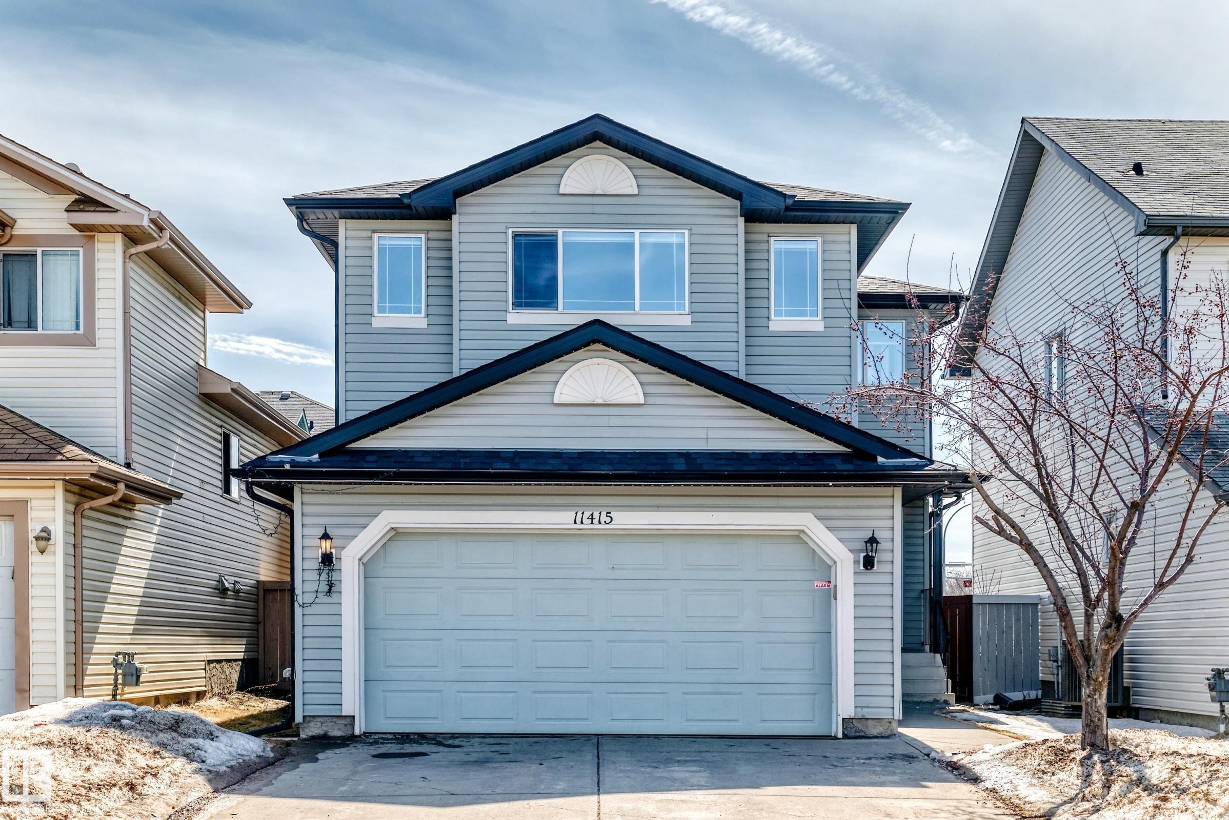This property features a two-story design with light blue siding and a dark roof - 11415 167A Avenue Nw, Edmonton, AB - Outdoor With Exterior
