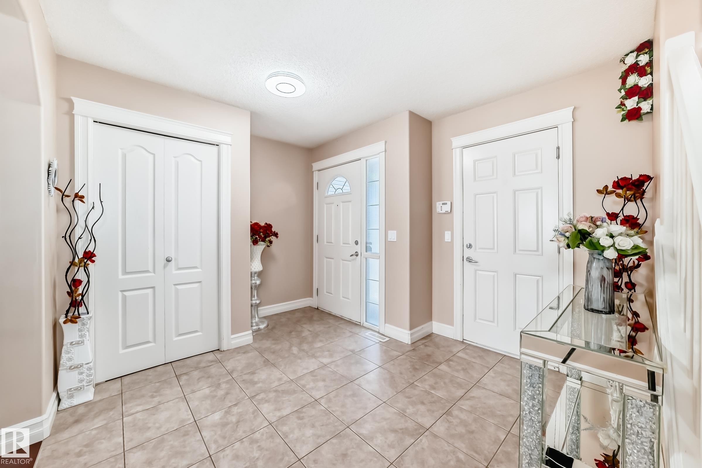 The property features an entryway with tile flooring, white doors, and light-colored walls - 11415 167A Avenue Nw, Edmonton, AB - Indoor Photo Showing Other Room