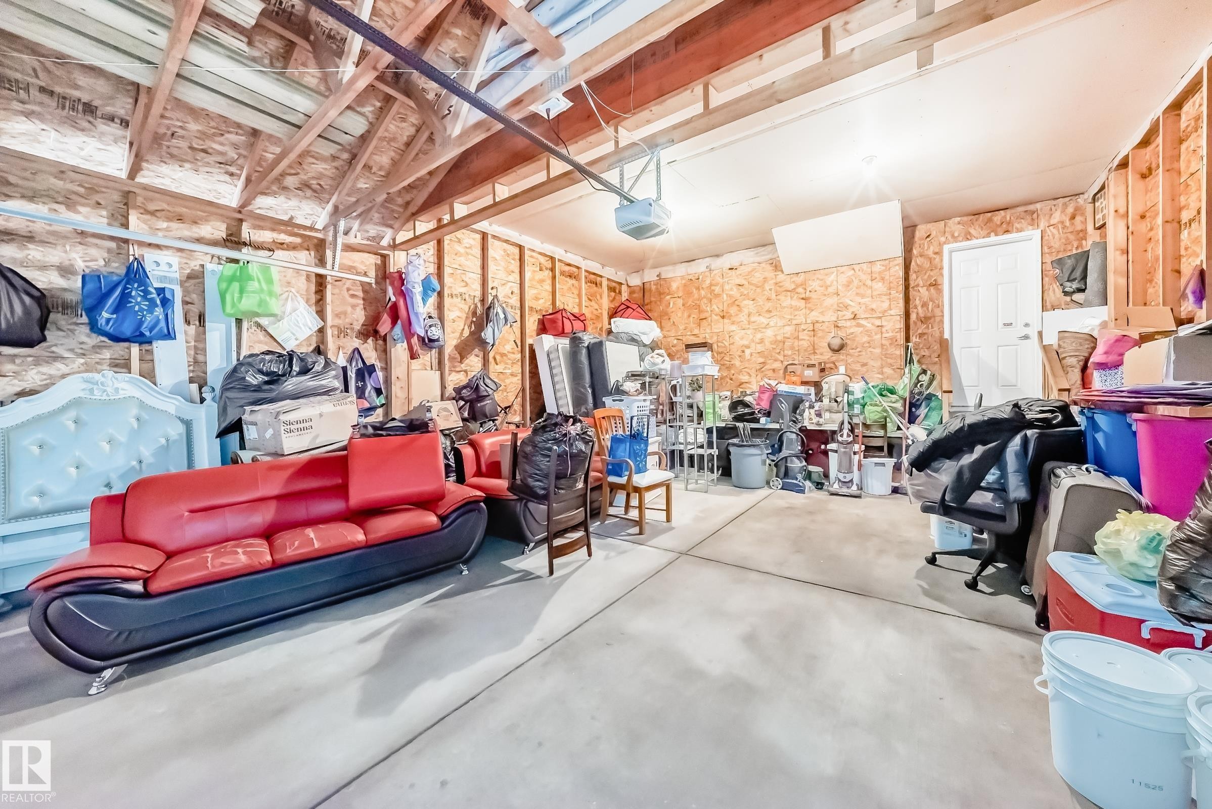Attached garage with exposed wood beam ceiling and concrete flooring - 11415 167A Avenue Nw, Edmonton, AB - Indoor Photo Showing Garage