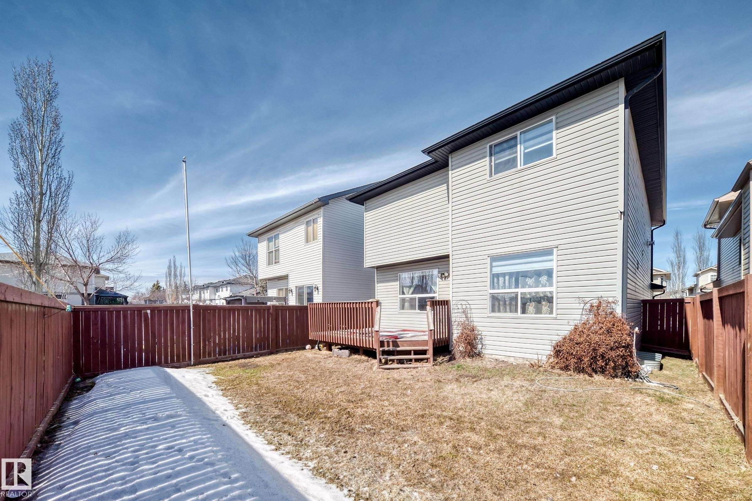 The property features a fenced yard with a wooden deck - 11415 167A Avenue Nw, Edmonton, AB - Outdoor