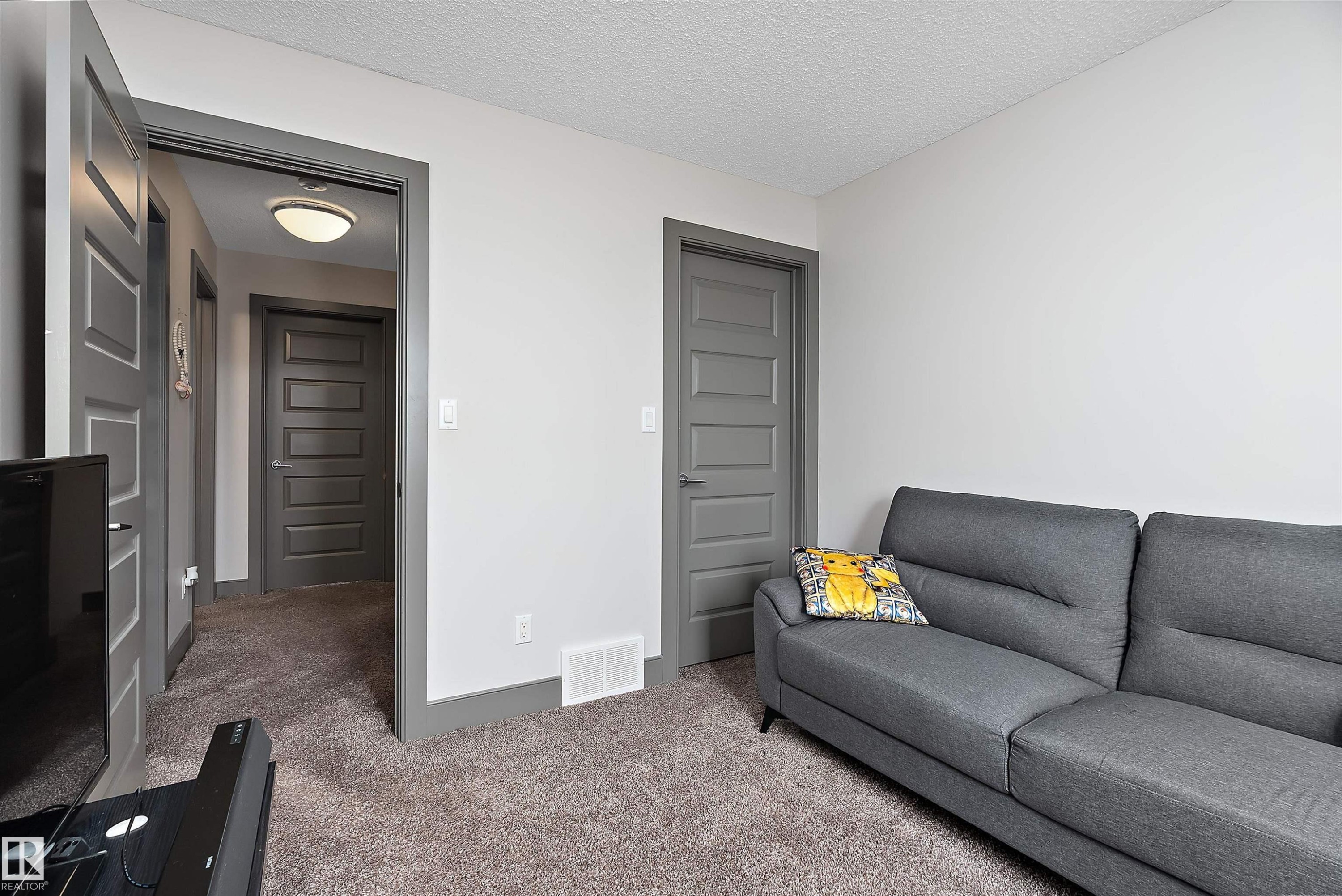 This room features light-colored walls and grey trim - 7776 Eifert Crescent Nw, Edmonton, AB - Indoor