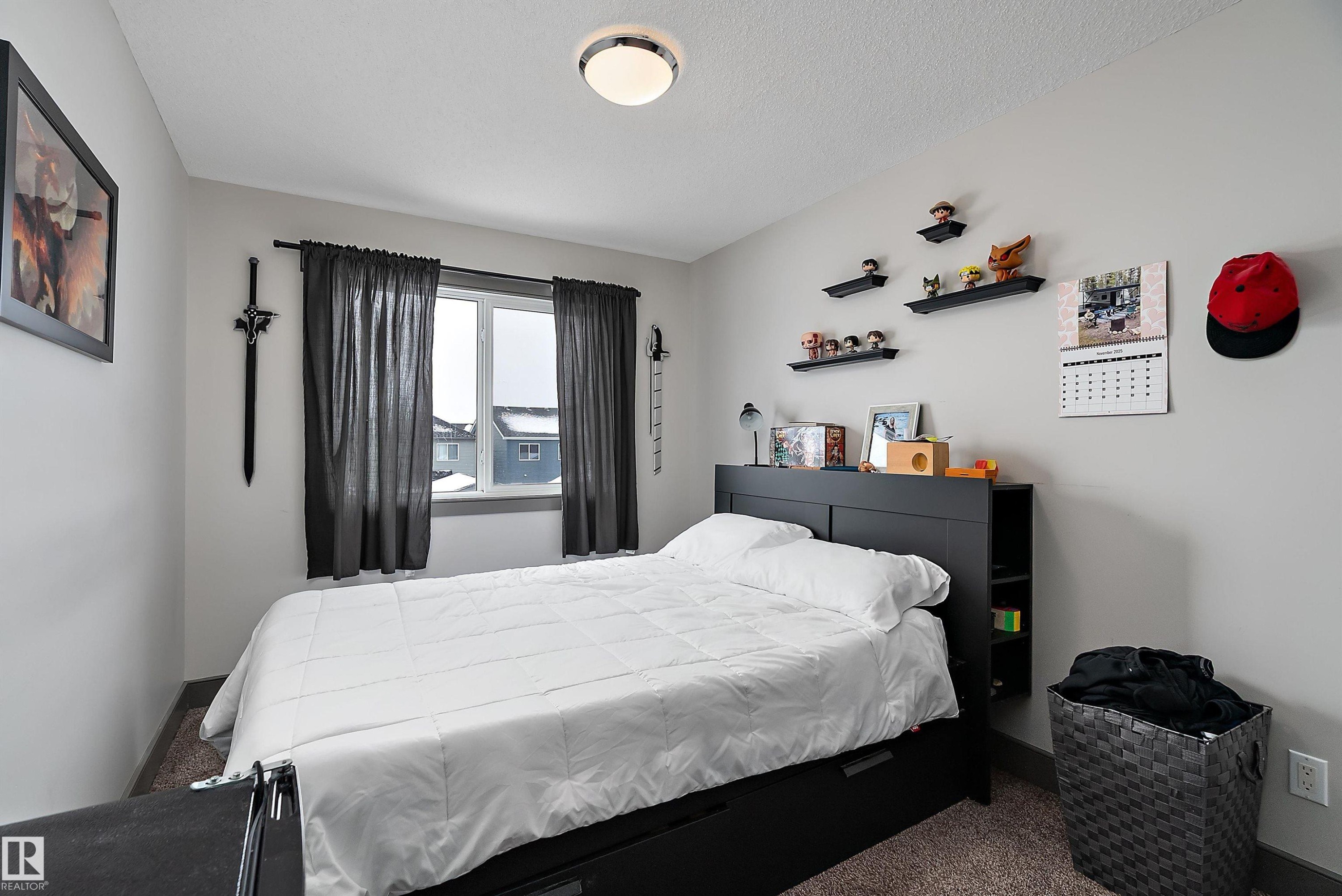 Bedroom featuring carpet flooring, a window with dark curtains, and a ceiling light fixture - 7776 Eifert Crescent Nw, Edmonton, AB - Indoor Photo Showing Bedroom