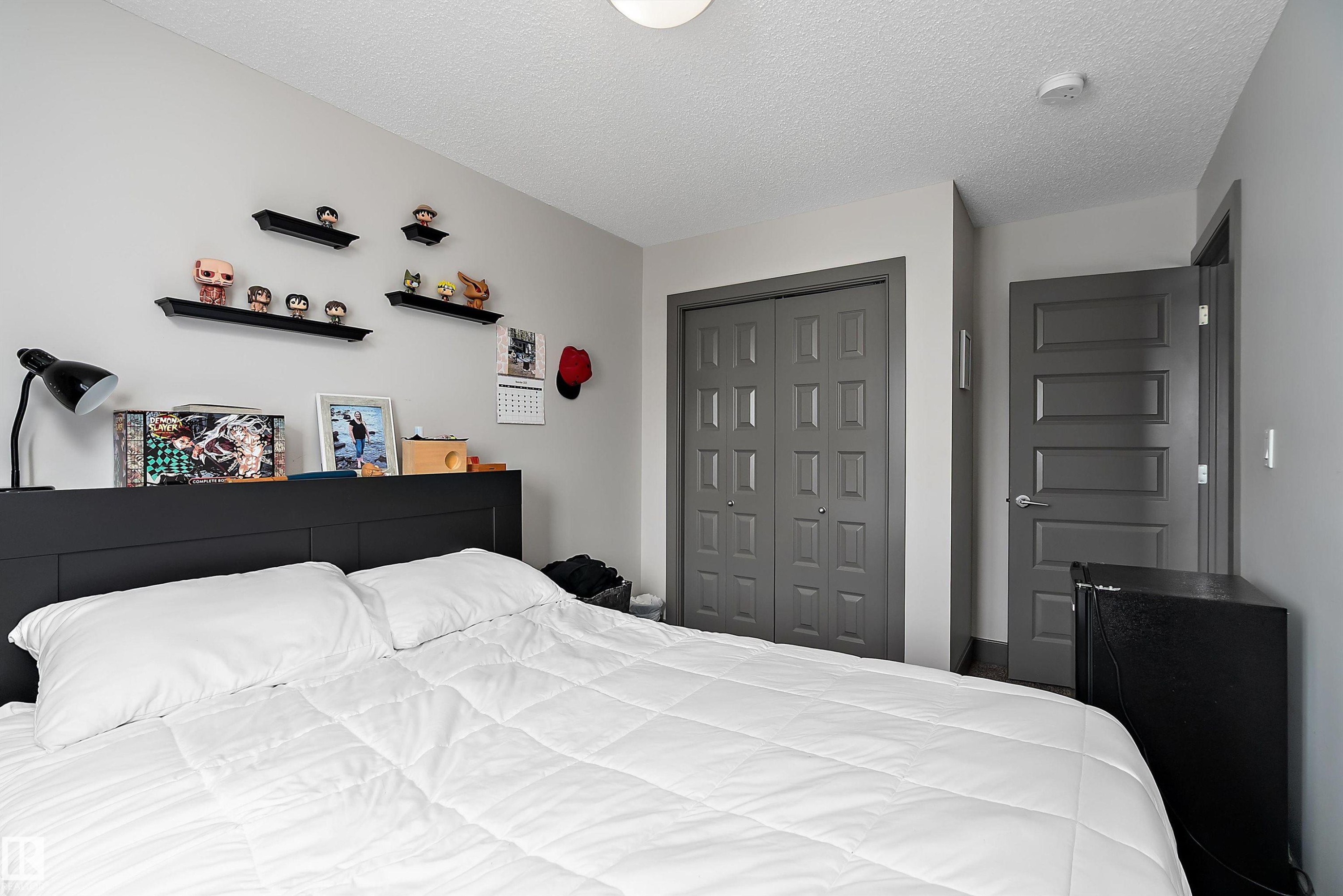 This room features light grey walls and a ceiling with a textured finish - 7776 Eifert Crescent Nw, Edmonton, AB - Indoor Photo Showing Bedroom
