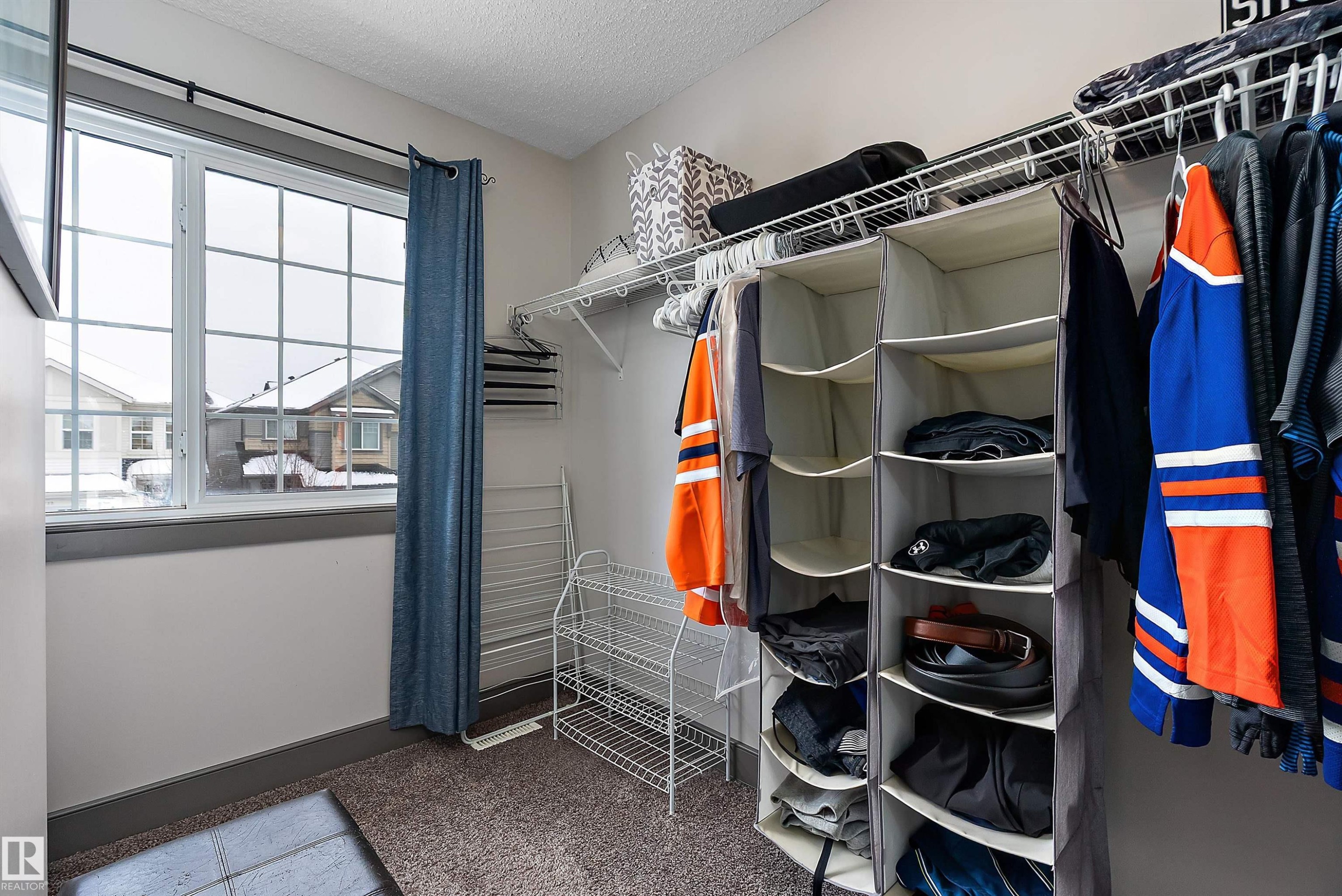 This functional closet features wire shelving and a window with a view of the surrounding properties - 7776 Eifert Crescent Nw, Edmonton, AB - Indoor With Storage