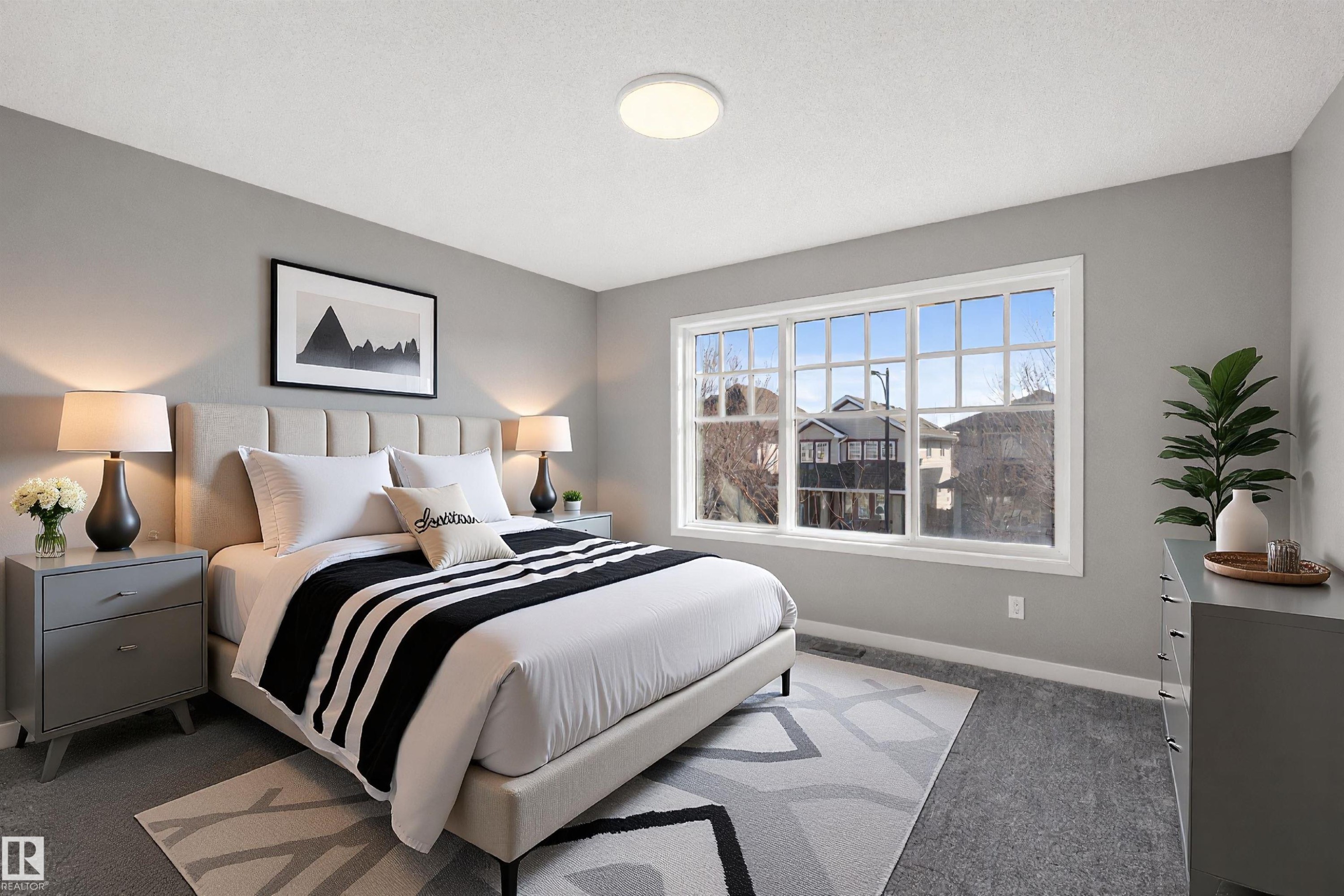 This bedroom features a large window with white framing, providing abundant natural light - 4016 Allan Crescent, Edmonton, AB - Indoor Photo Showing Bedroom