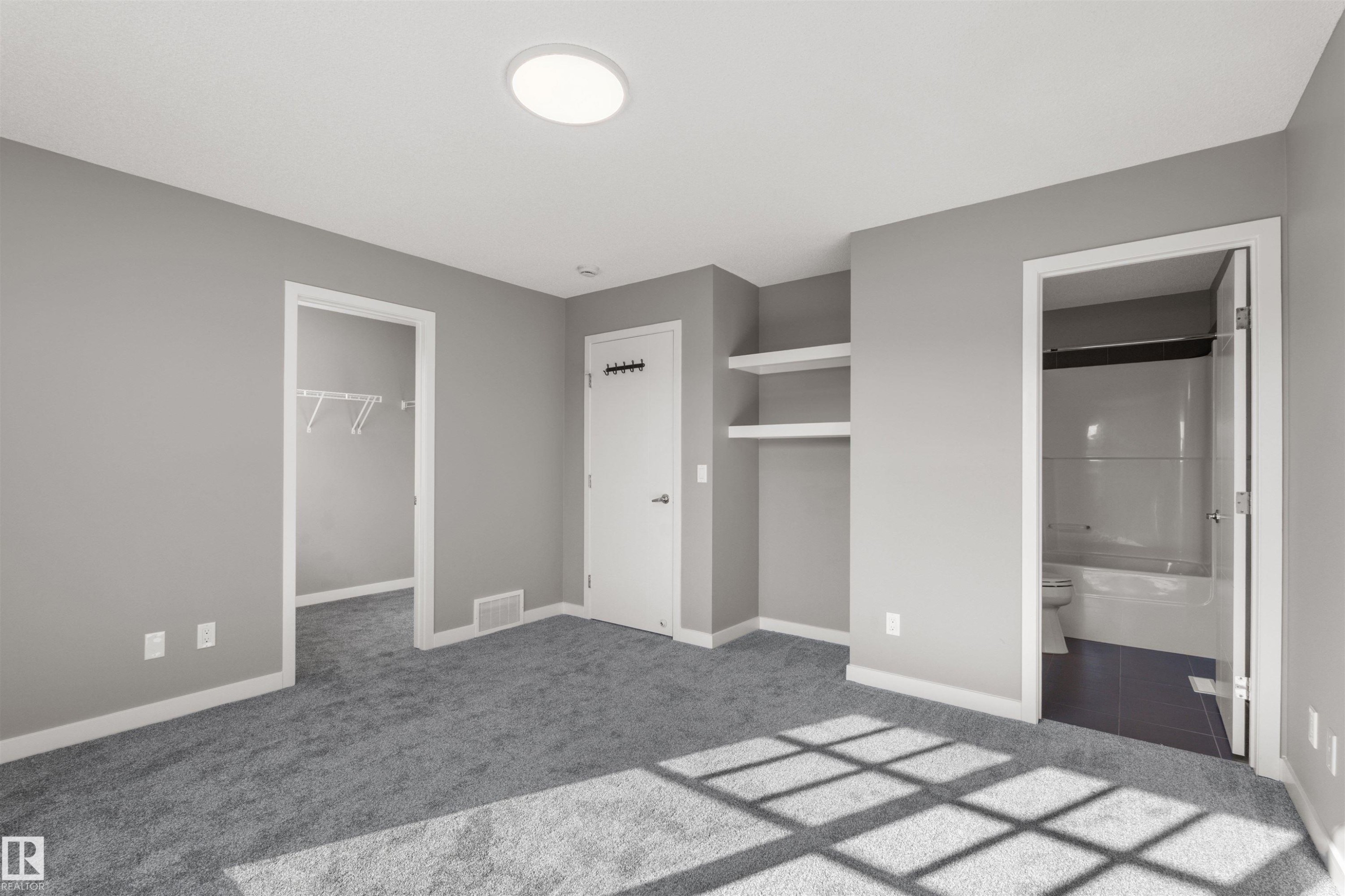 This room features plush grey carpeting, light grey walls, and a modern ceiling light fixture - 4016 Allan Crescent, Edmonton, AB - Indoor Photo Showing Other Room