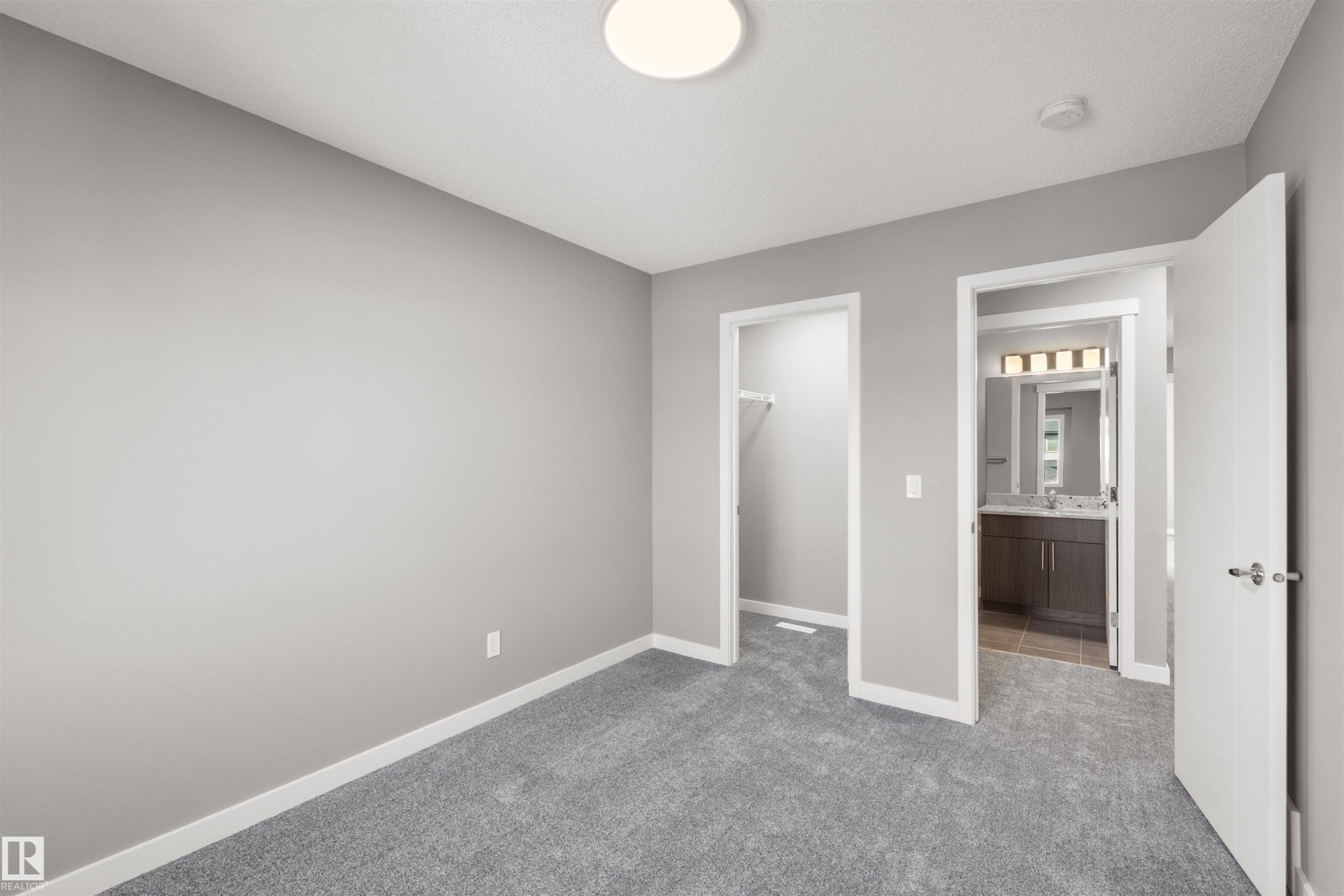 This room features light grey walls, grey carpet, and white trim - 4016 Allan Crescent, Edmonton, AB - Indoor Photo Showing Other Room