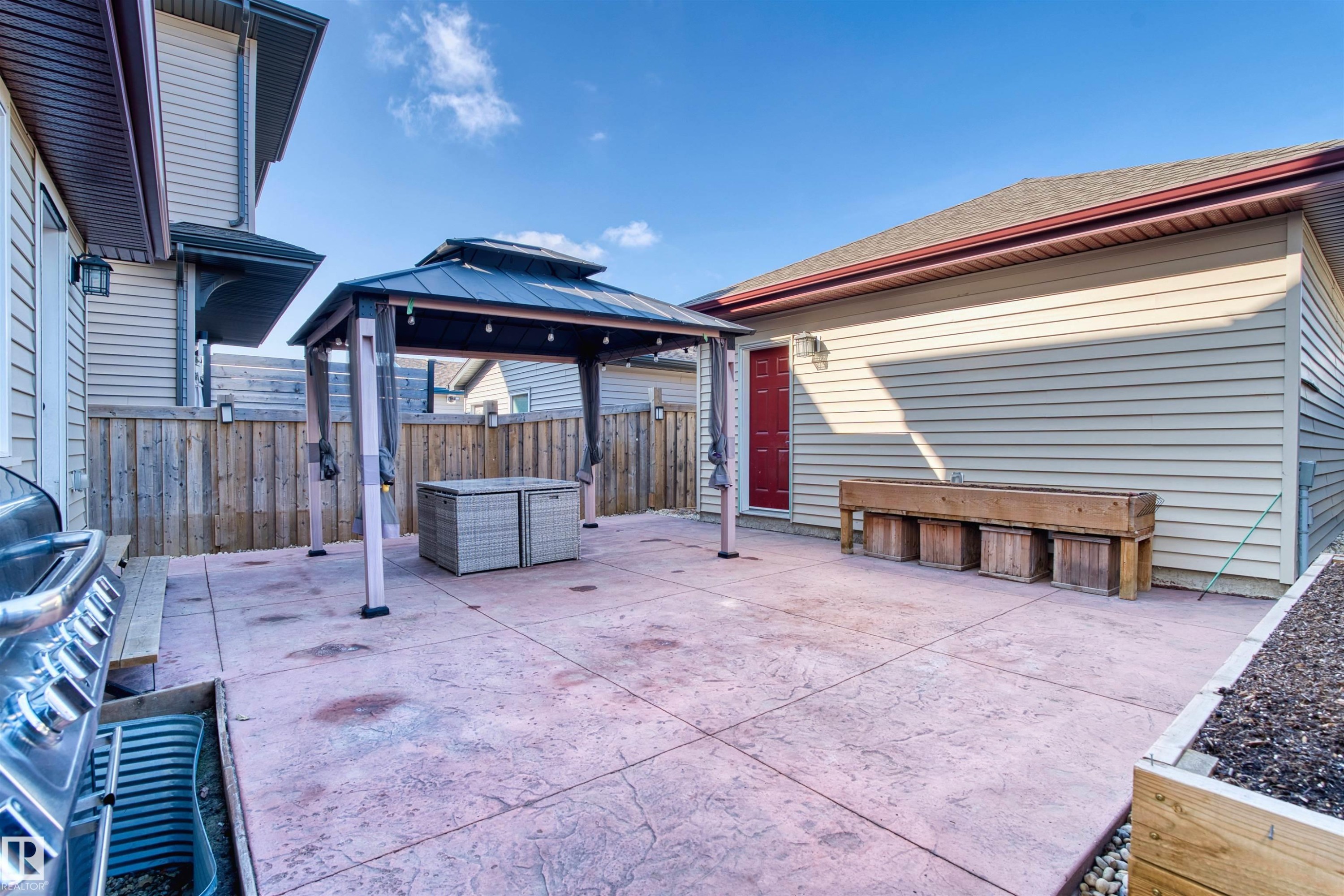 The property features a concrete patio area with a gazebo, providing an outdoor living space - 4016 Allan Crescent, Edmonton, AB - Outdoor With Deck Patio Veranda With Exterior