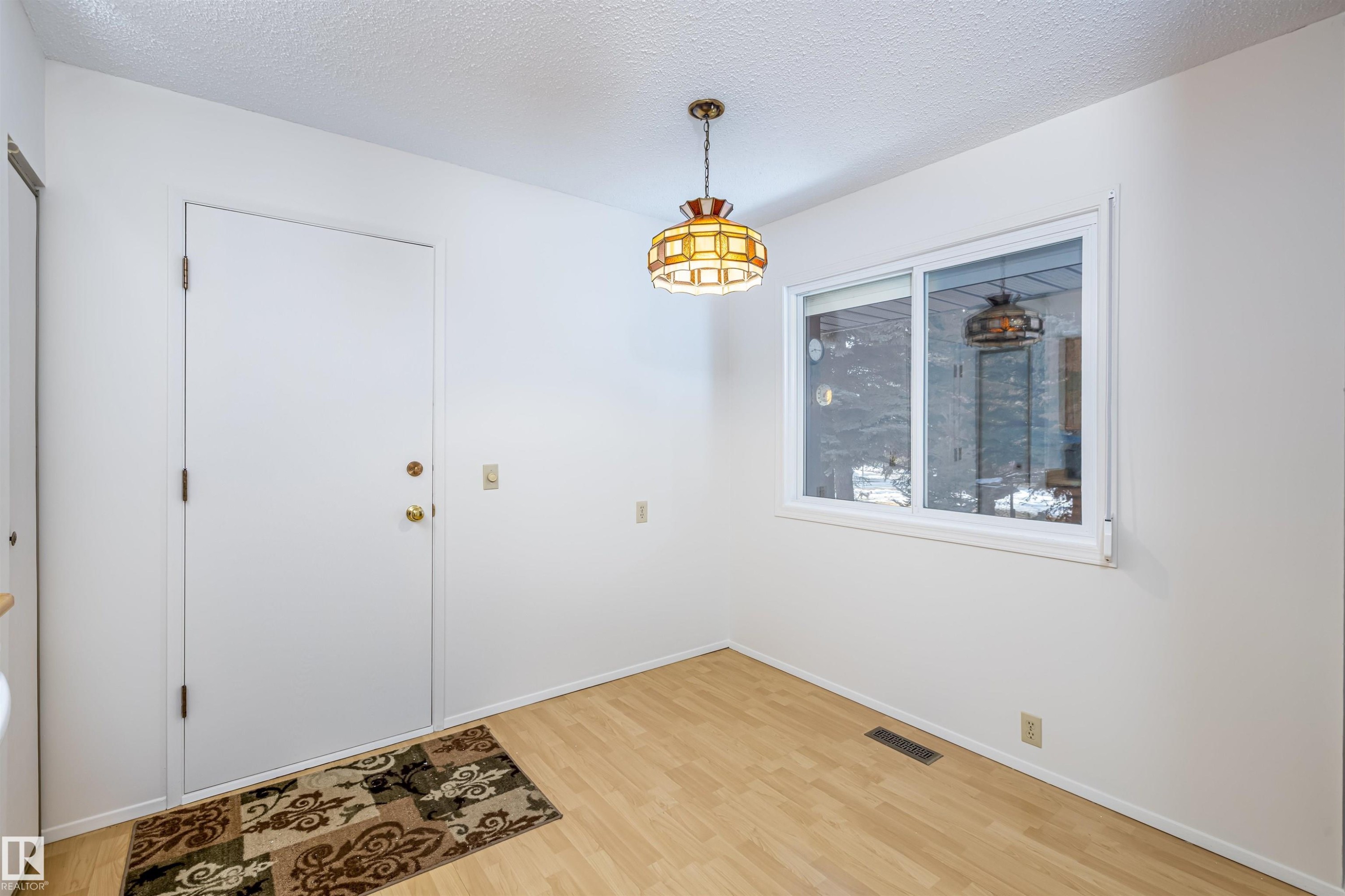 This room features light wood flooring, white walls, and a large window providing natural light - 108 Forest Grove, St. Albert, AB - Indoor Photo Showing Other Room