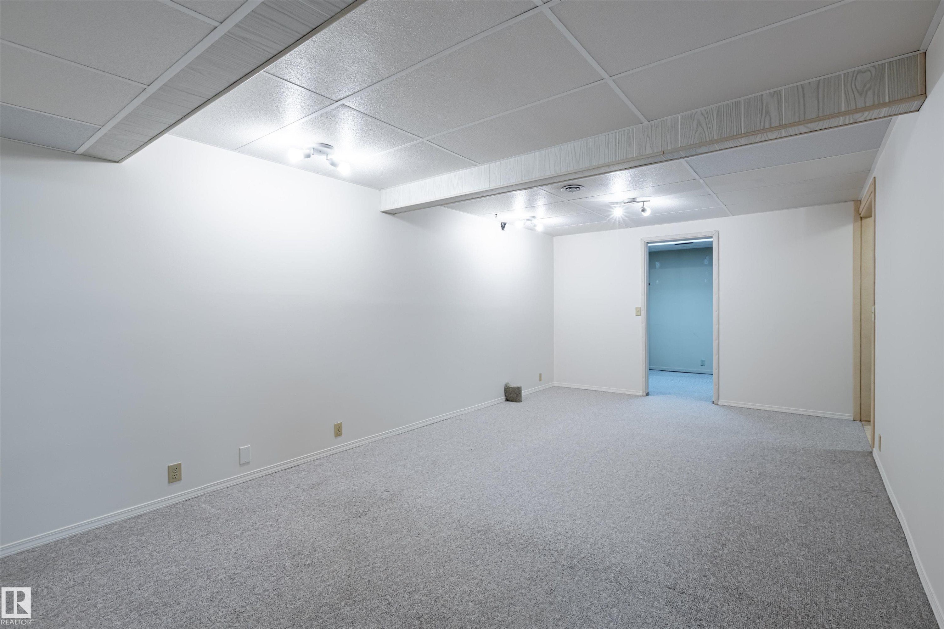 Spacious room featuring light grey carpeting, white walls, and track lighting - 108 Forest Grove, St. Albert, AB - Indoor