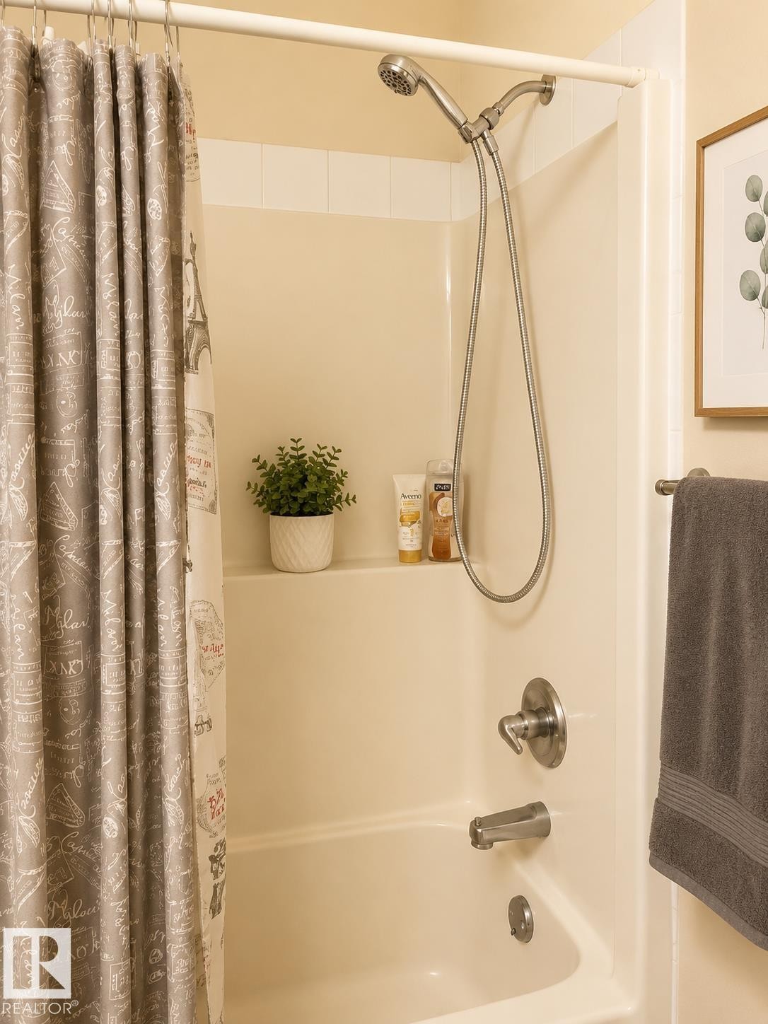 Tub and shower combination featuring a brushed nickel showerhead and faucet - 336 9525 162 Avenue, Edmonton, AB - Indoor Photo Showing Bathroom