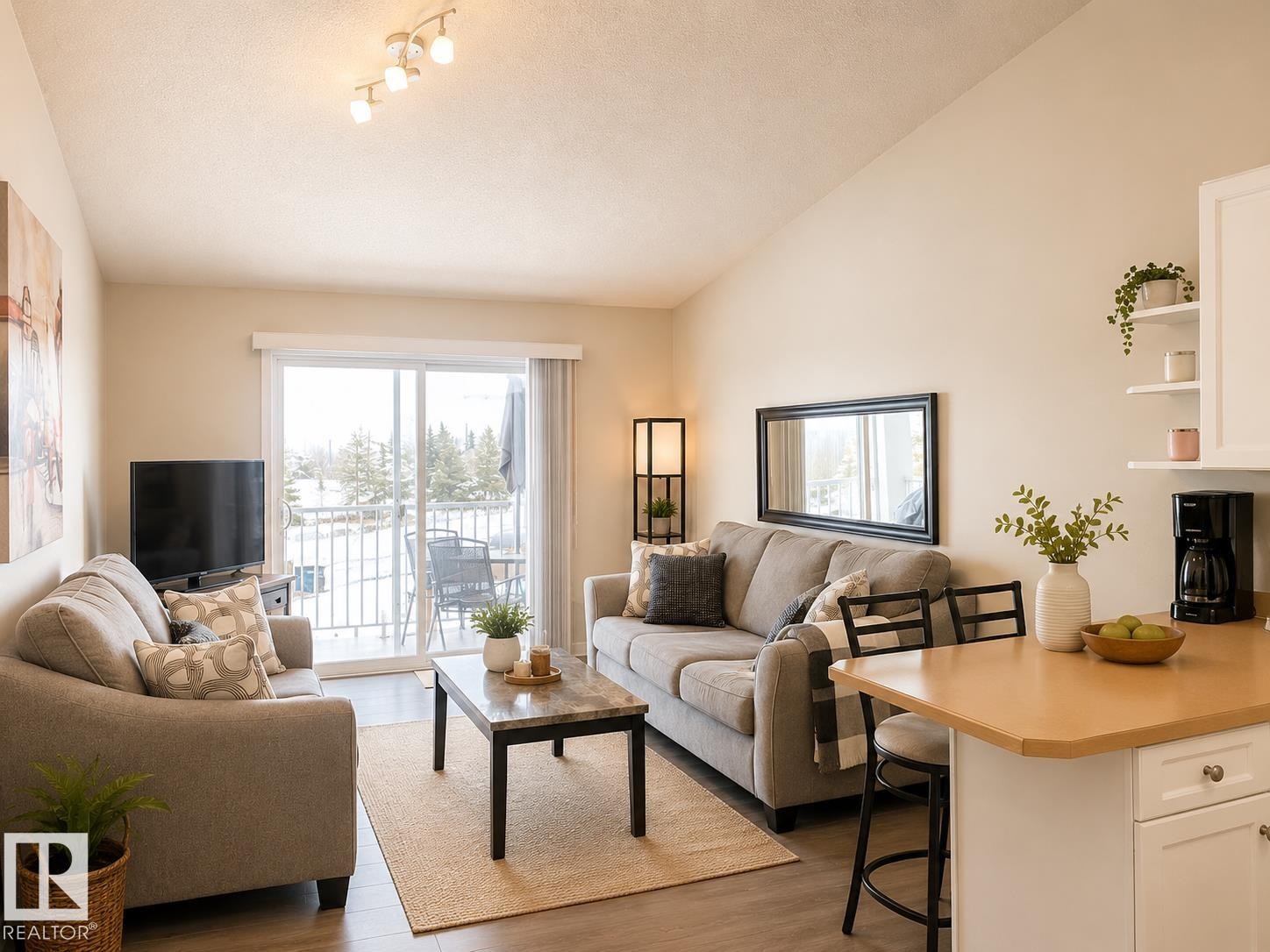 Open-concept living space featuring vaulted ceilings and wood-finish flooring - 336 9525 162 Avenue, Edmonton, AB - Indoor Photo Showing Living Room