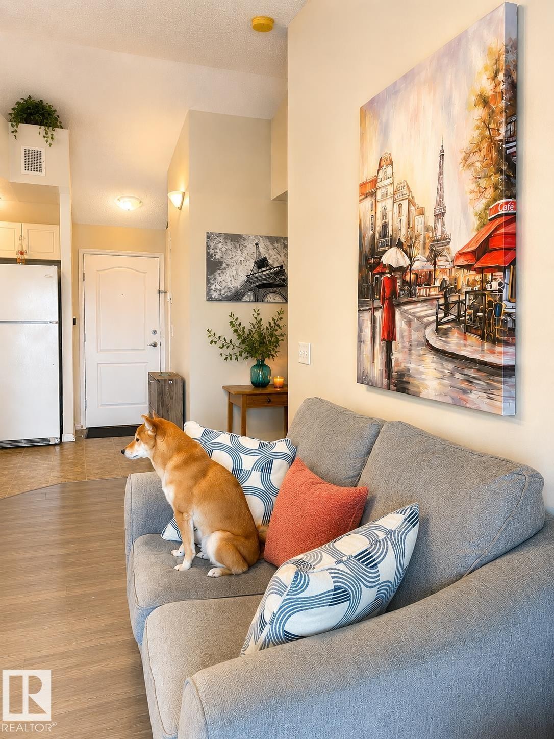 Open-concept living space featuring wood-finish flooring, recessed lighting, and a white paneled entry door - 336 9525 162 Avenue, Edmonton, AB - Indoor Photo Showing Living Room