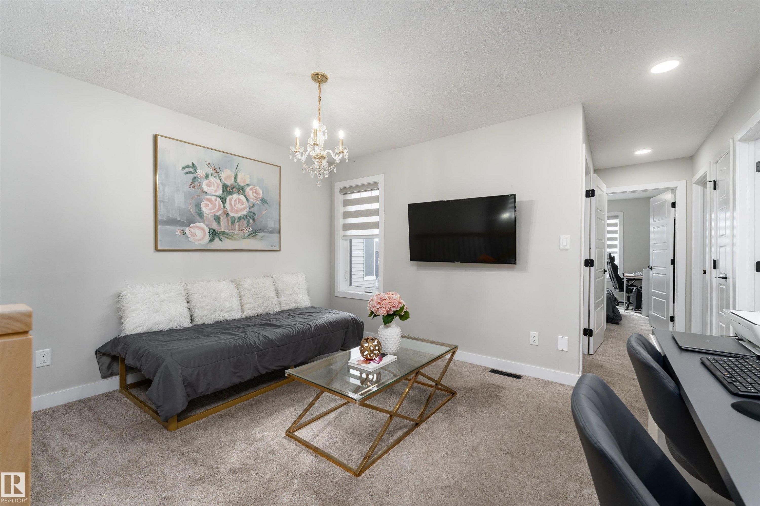 This bright interior space features neutral-toned walls and carpeting - 993 Berg Pl, Leduc, AB - Indoor Photo Showing Living Room