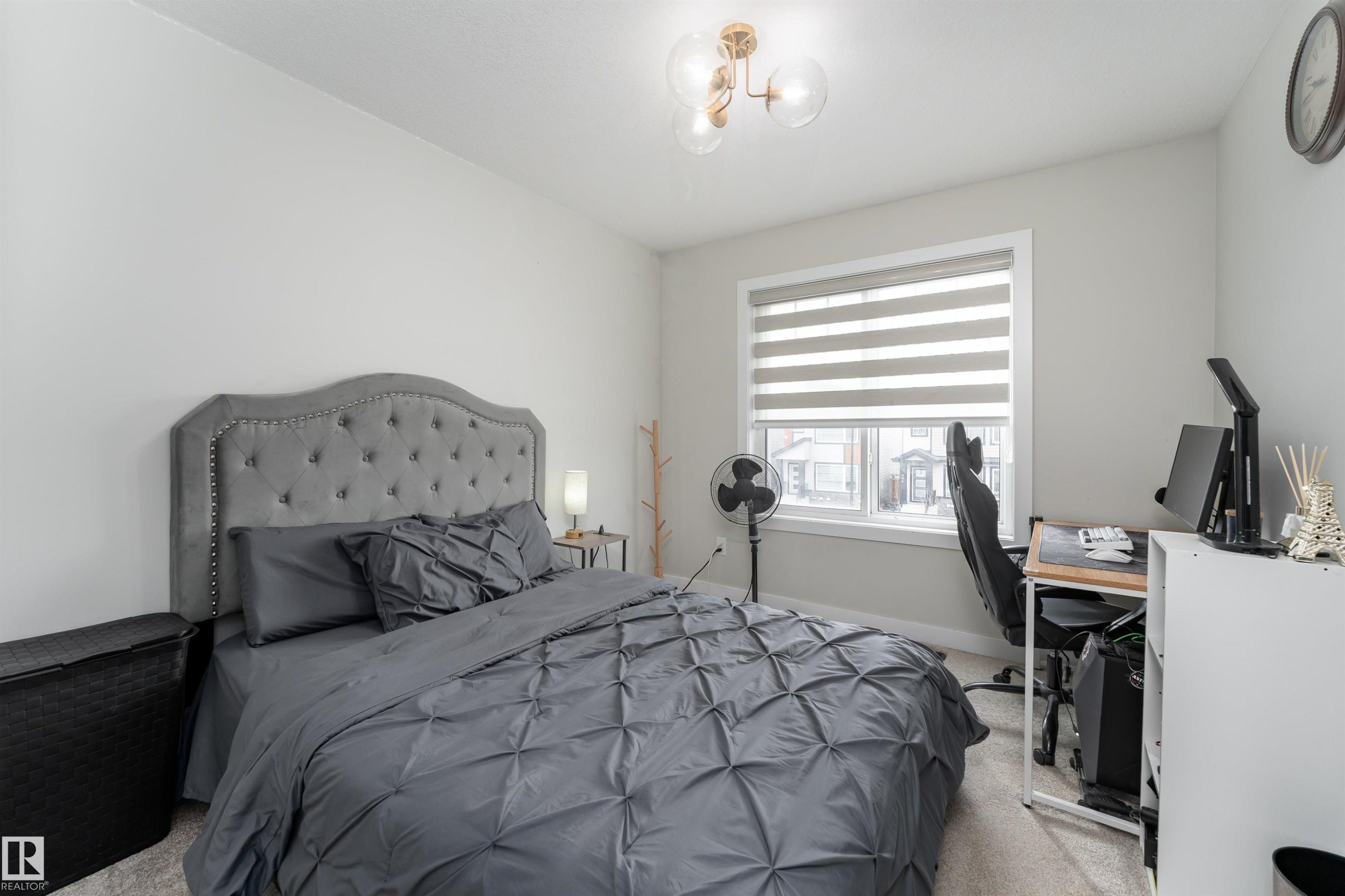 Bedroom with light-colored walls and a window with blinds - 993 Berg Pl, Leduc, AB - Indoor Photo Showing Bedroom