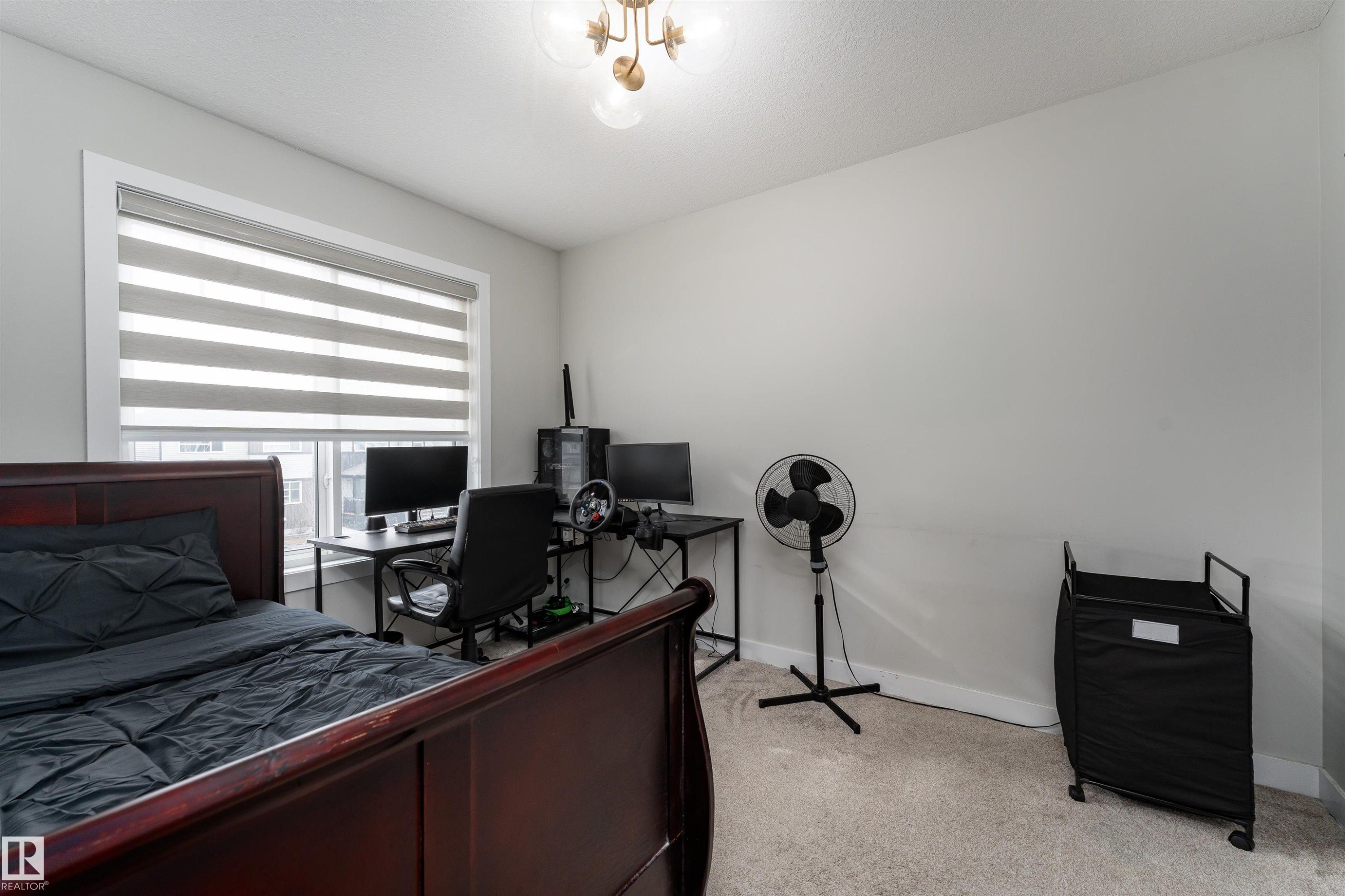 Bedroom featuring light-colored walls, carpeted flooring, and a window with horizontal blinds - 993 Berg Pl, Leduc, AB - Indoor Photo Showing Other Room