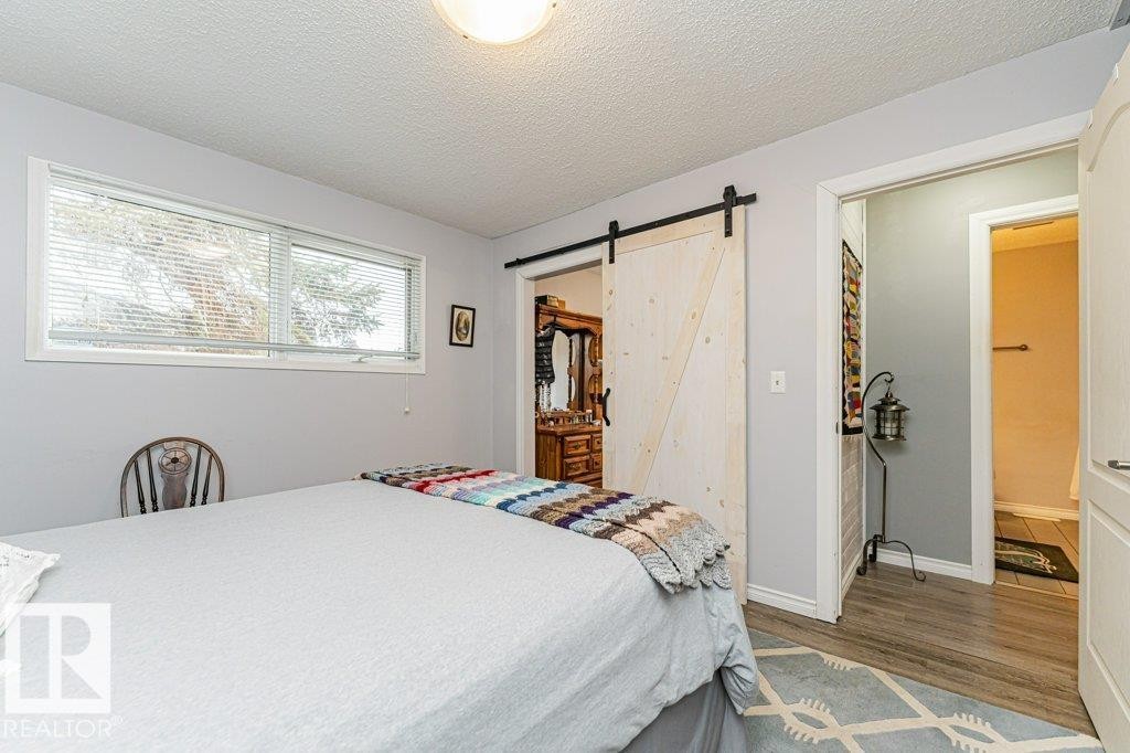 This room features light-colored walls and a window with blinds providing natural light - 8 Duke Drive, Lamont, AB - Indoor Photo Showing Bedroom
