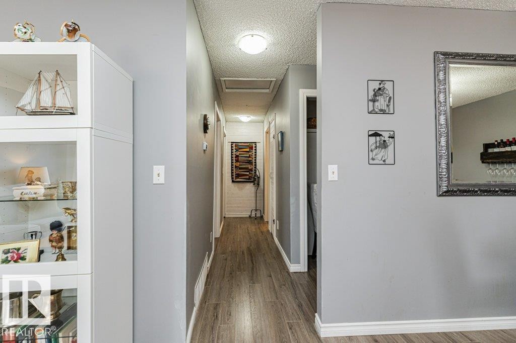 Hallway featuring wood-style flooring and light grey walls - 8 Duke Drive, Lamont, AB - Indoor Photo Showing Other Room