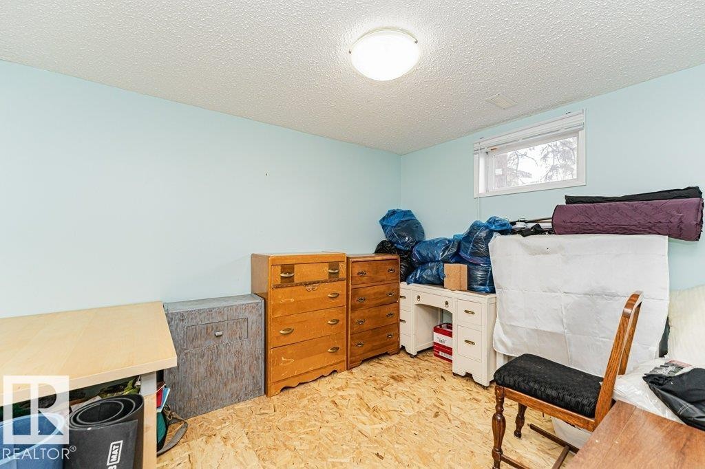 This room features light blue walls, a window with a white frame, and a ceiling light fixture - 8 Duke Drive, Lamont, AB - Indoor