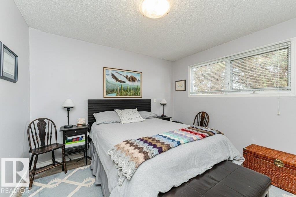 This room features light grey walls and a textured ceiling - 8 Duke Drive, Lamont, AB - Indoor Photo Showing Bedroom