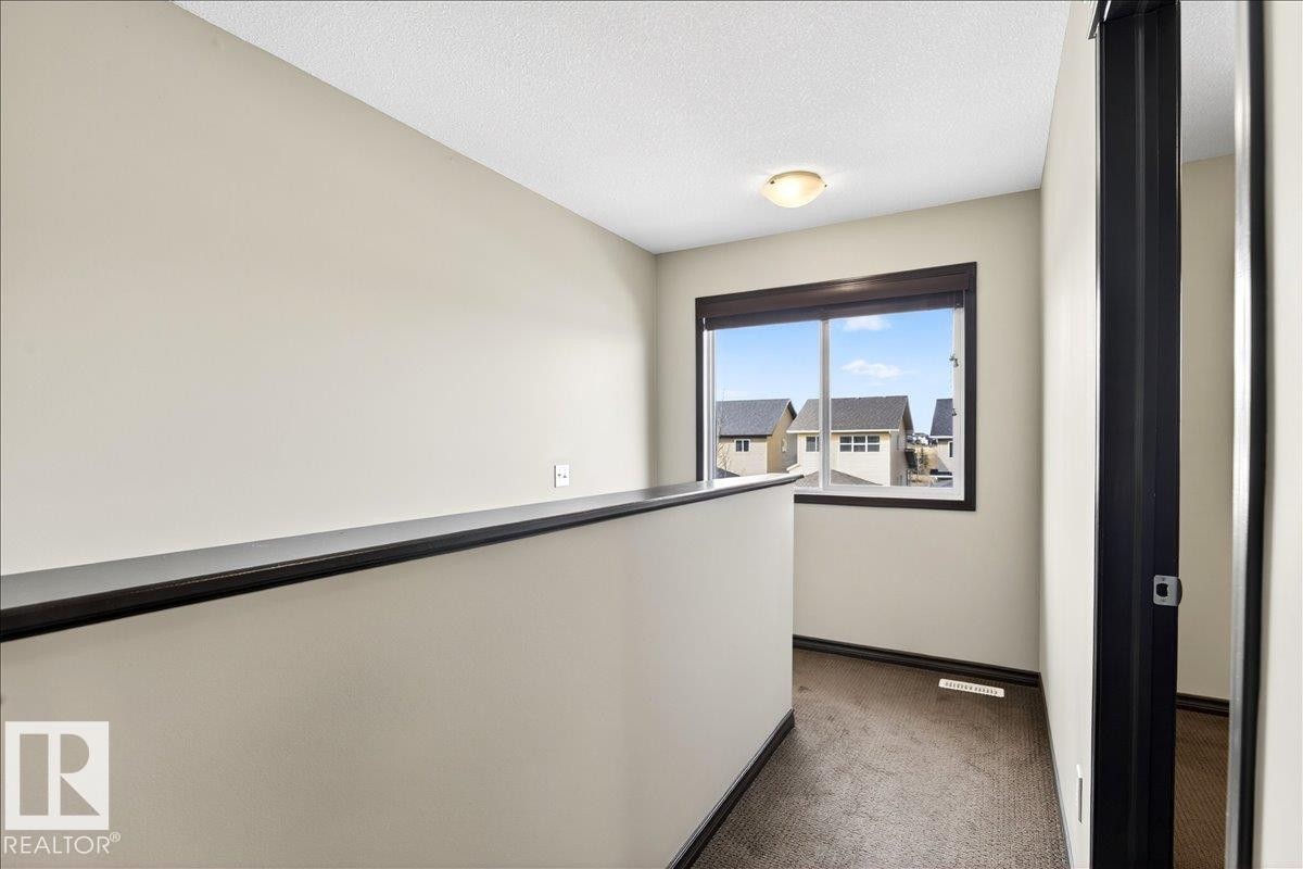 The property features light-colored walls and carpeted flooring - 1530 Chapman Way, Edmonton, AB - Indoor Photo Showing Other Room