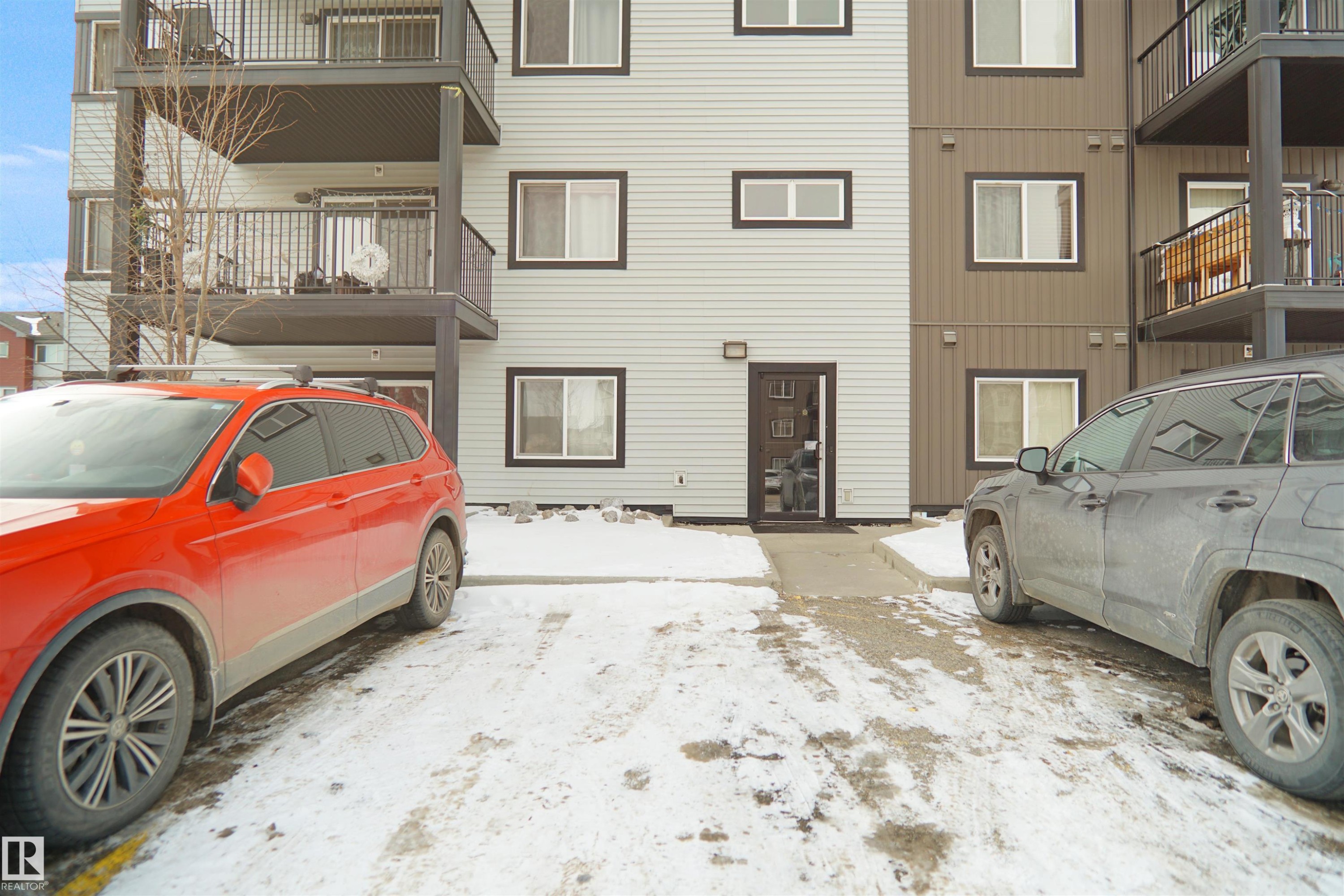 The property features a multi-story building with balconies and a main entrance - 103 3353 16A Avenue, Edmonton, AB - Outdoor With Exterior
