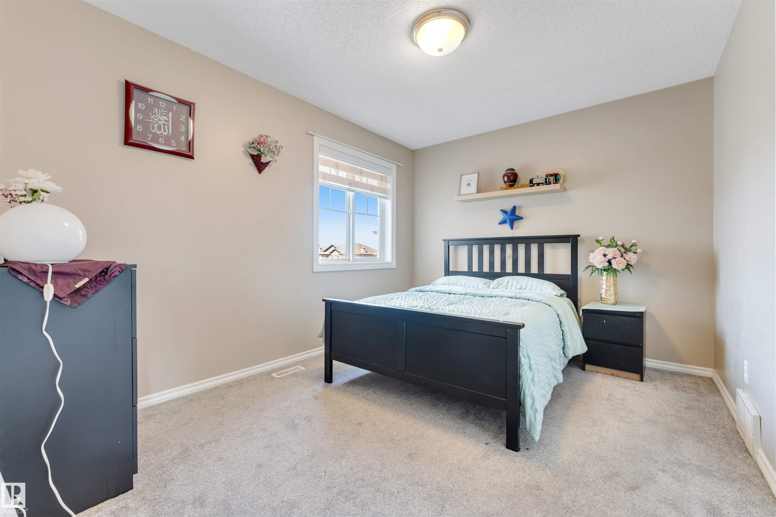 This room features light-colored walls, carpeted flooring, and a window with blinds - 121 64 Street, Edmonton, AB - Indoor Photo Showing Bedroom
