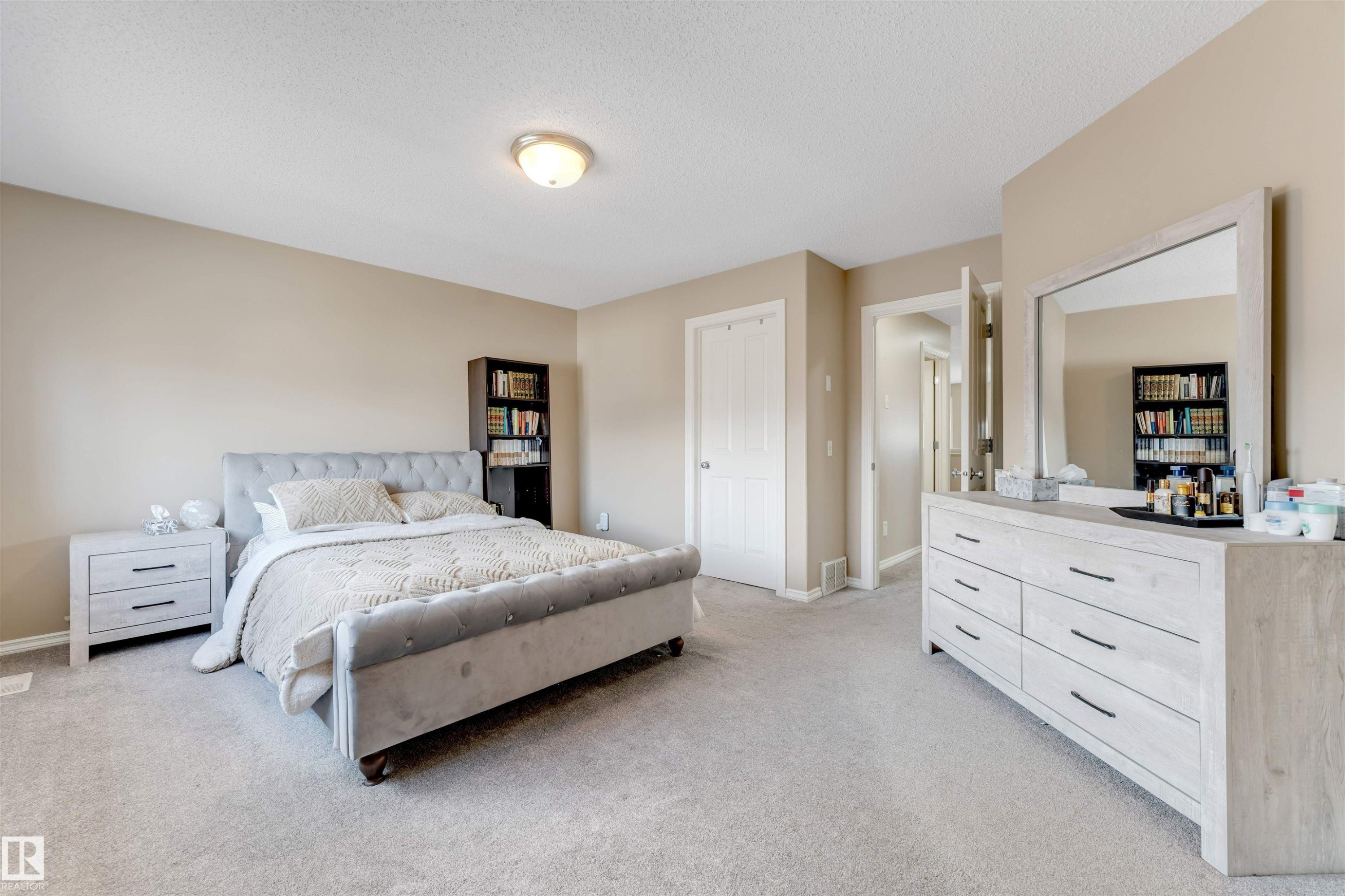 This room features light beige walls and a light-colored carpet, creating a neutral and inviting atmosphere - 121 64 Street, Edmonton, AB - Indoor Photo Showing Bedroom
