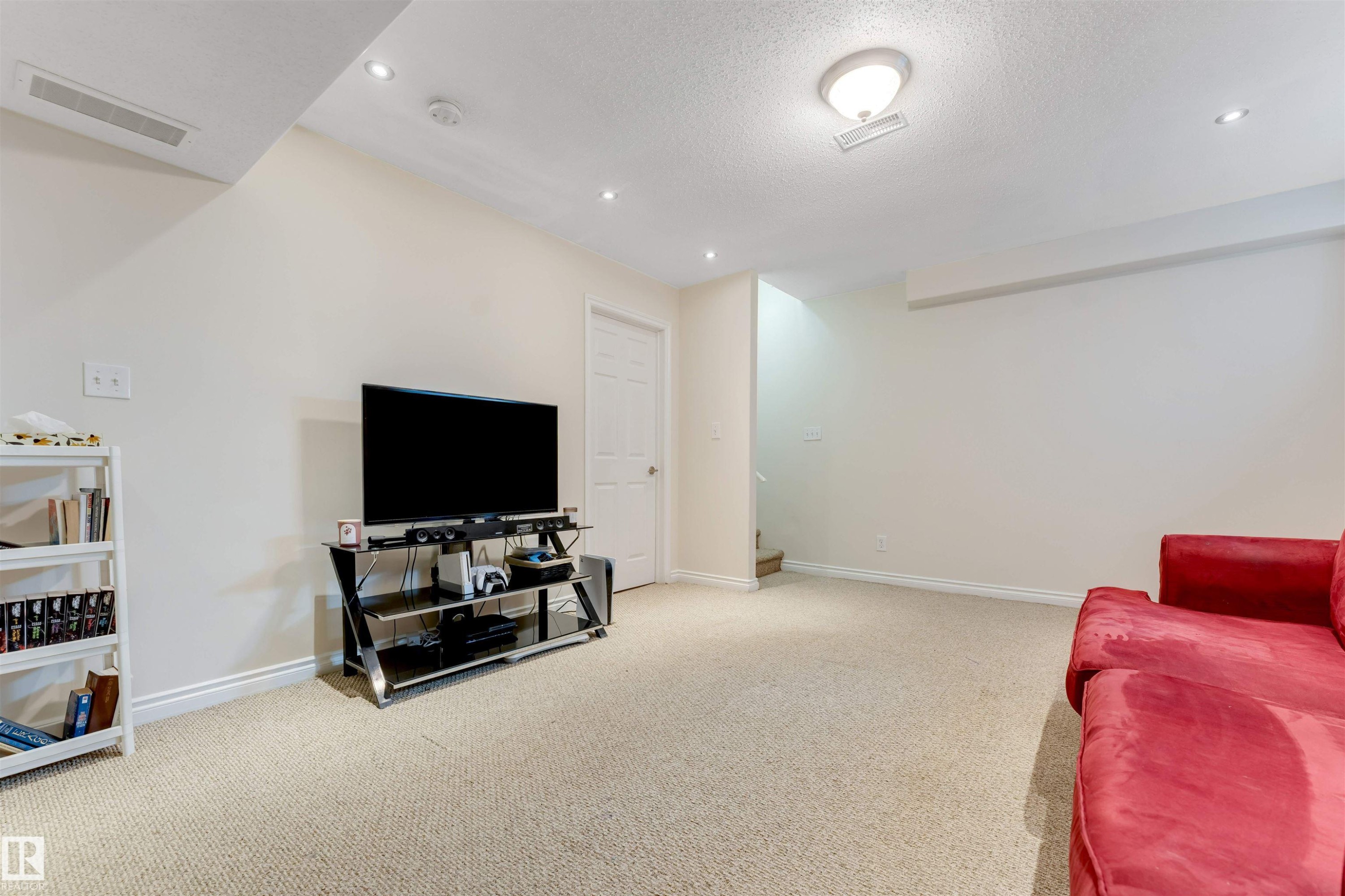 Spacious room with light-colored carpeting, recessed lighting, and a neutral wall color - 121 64 Street, Edmonton, AB - Indoor