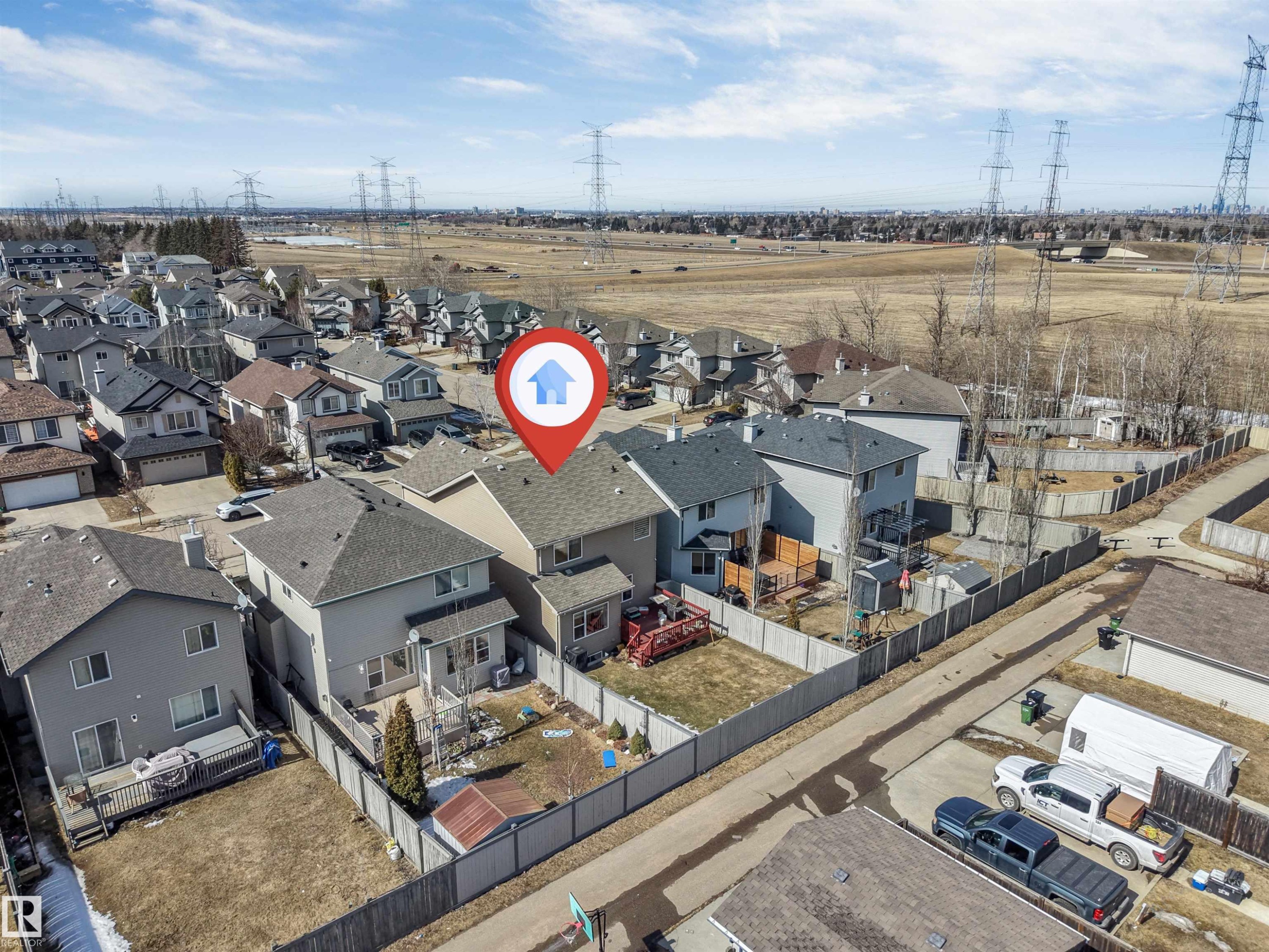 Aerial view of the property, showcasing the rear exterior with a deck and fenced yard - 121 64 Street, Edmonton, AB - Outdoor With View