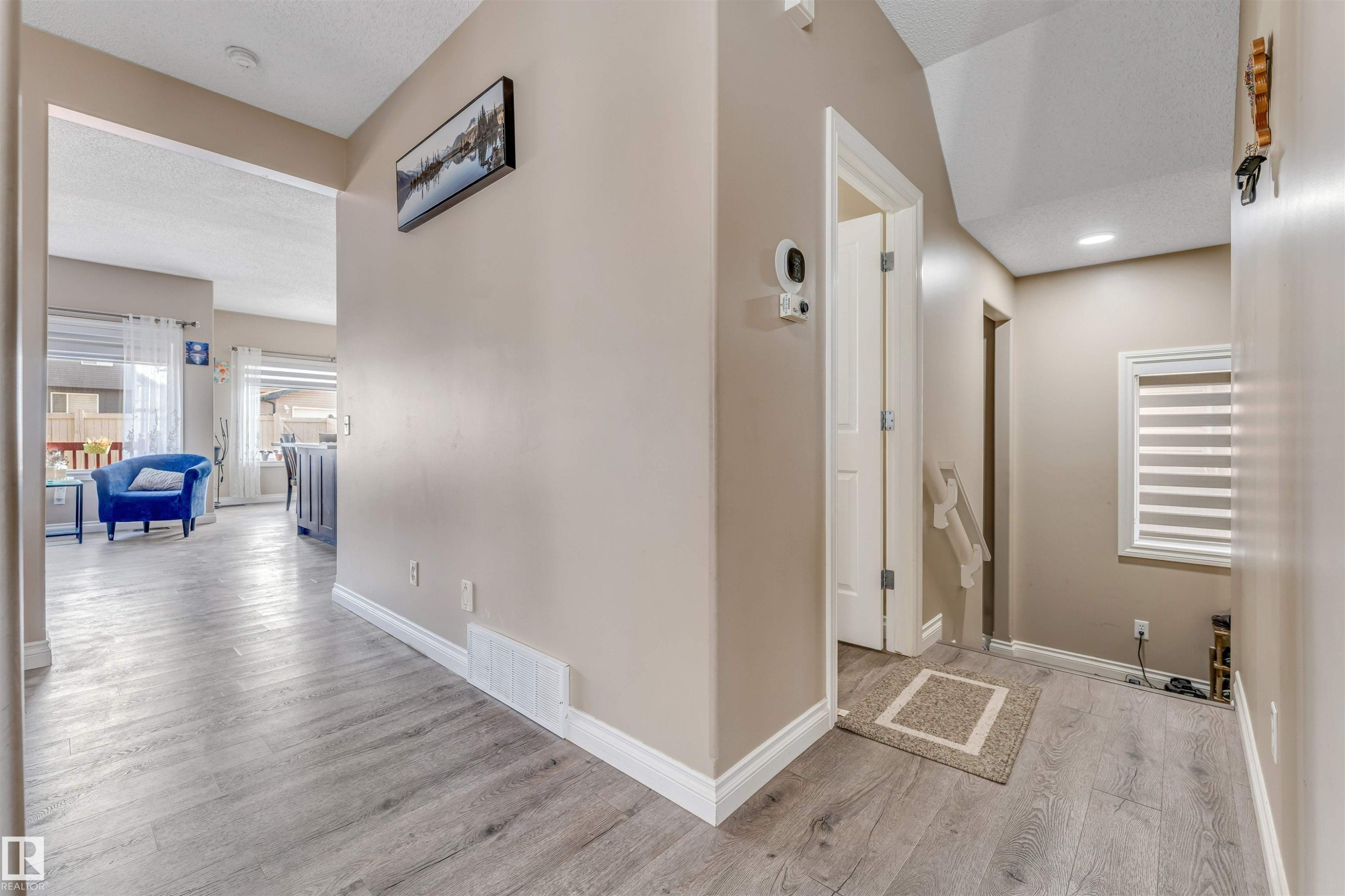 This property features light-toned flooring throughout, offering a cohesive aesthetic - 121 64 Street, Edmonton, AB - Indoor Photo Showing Other Room